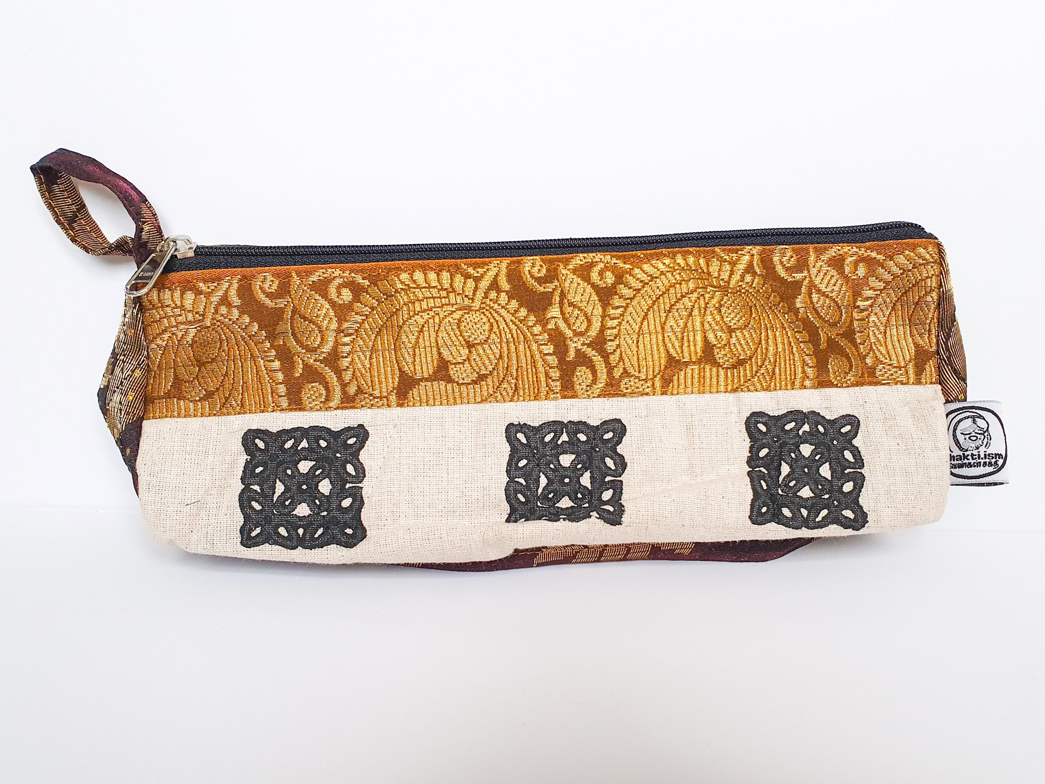 A vibrant Sari Pencil Pouch made from reclaimed sari fabric, showcasing unique patterns and colors, ethically handmade by artisans in India.