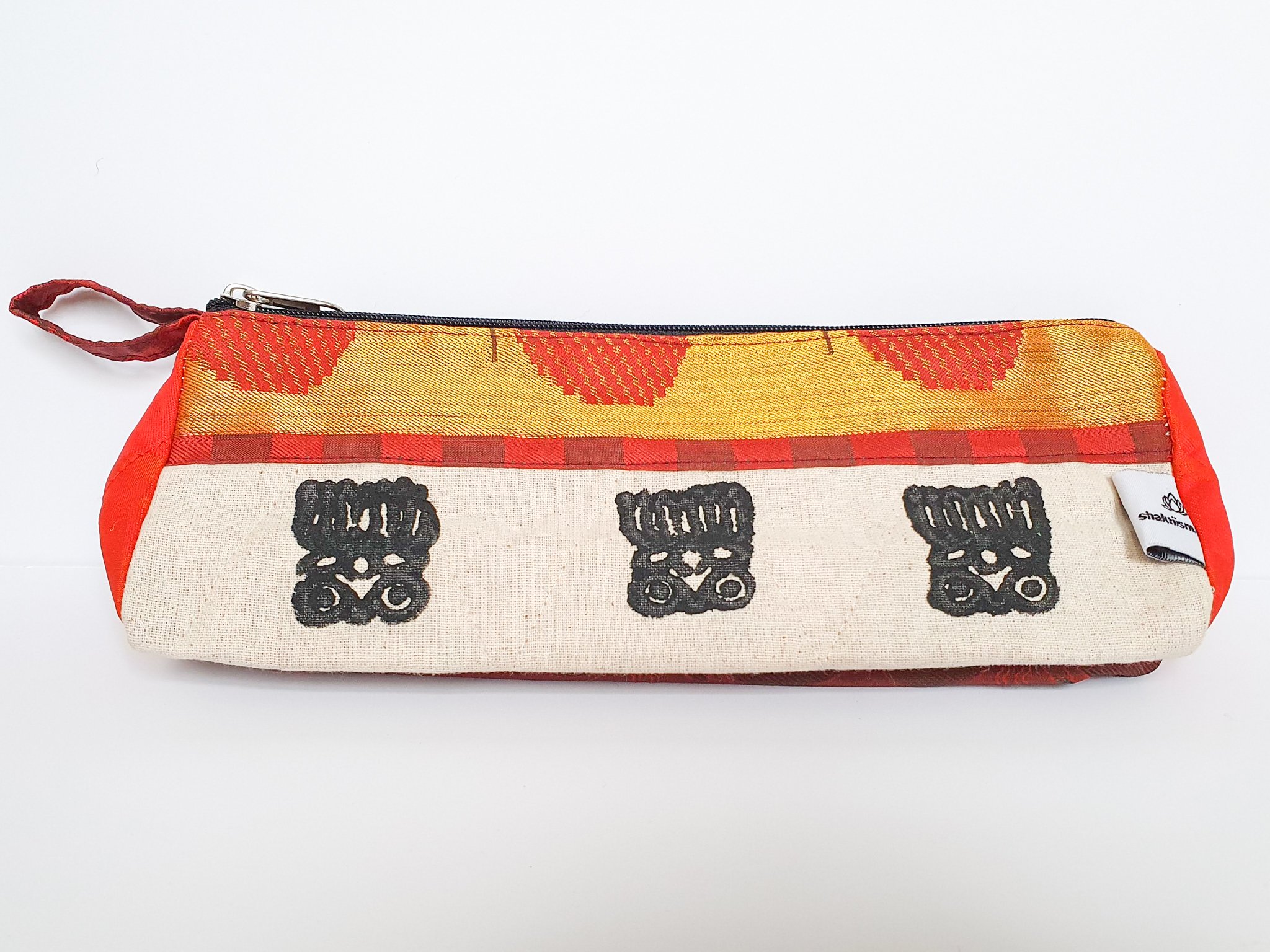 A vibrant Sari Pencil Pouch made from reclaimed sari fabric, showcasing unique patterns and colors, ethically handmade by artisans in India.