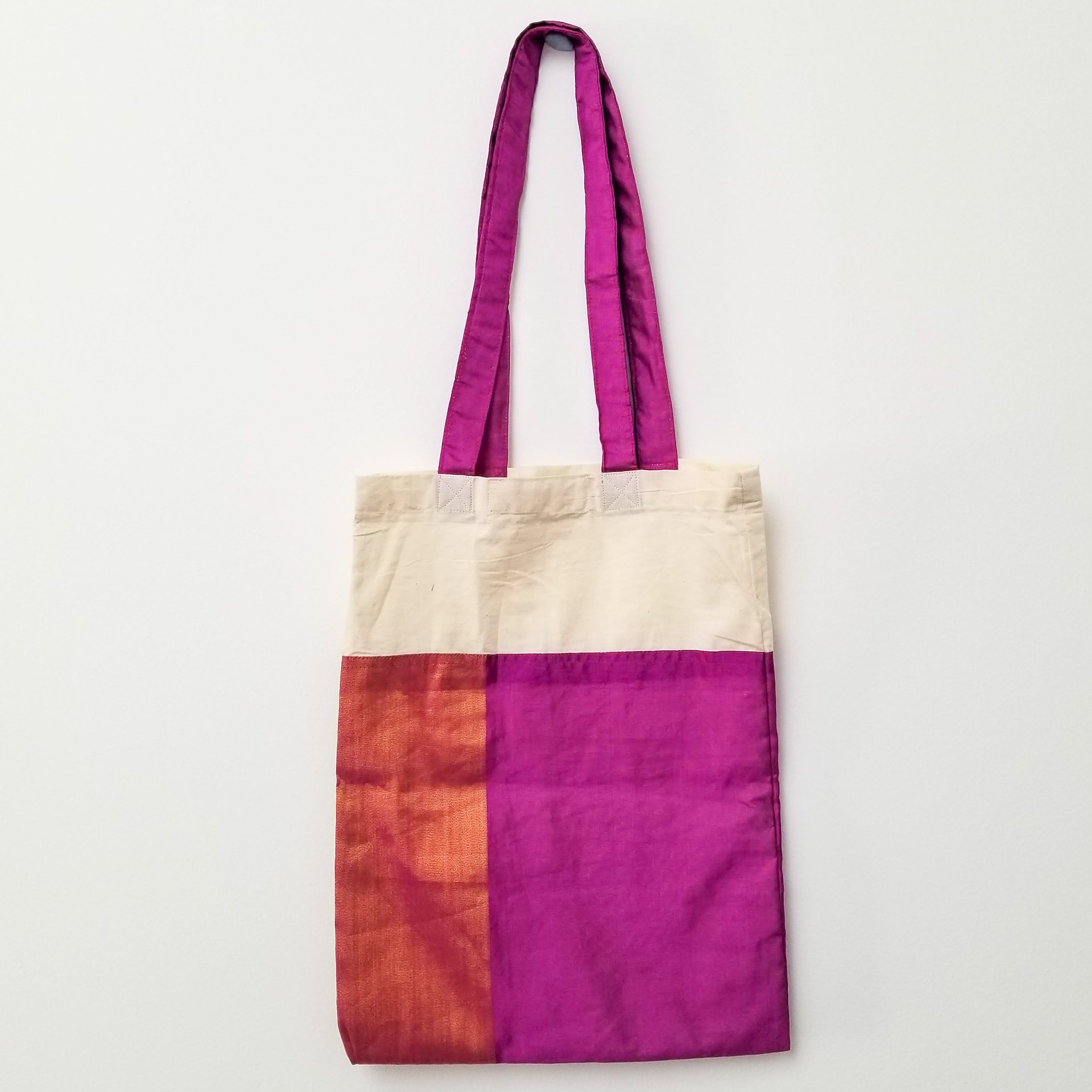 A vibrant Sari Tote Bag handcrafted from repurposed saris, showcasing unique patterns and colors, perfect for shopping and daily use.