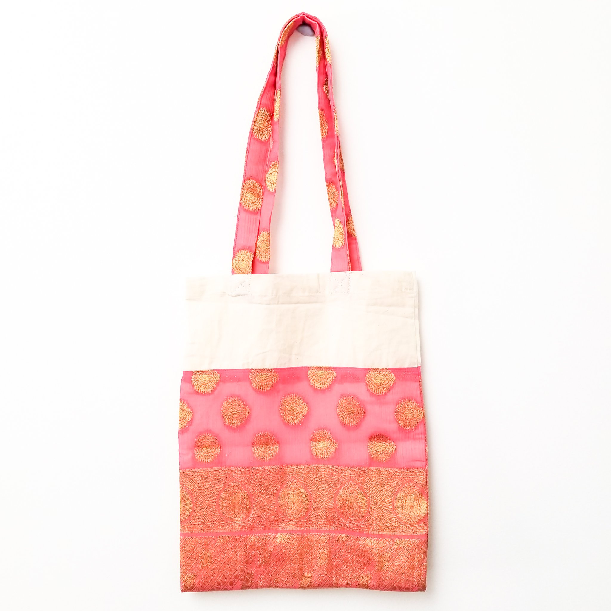 A vibrant Sari Tote Bag handcrafted from repurposed saris, showcasing unique patterns and colors, perfect for shopping and daily use.