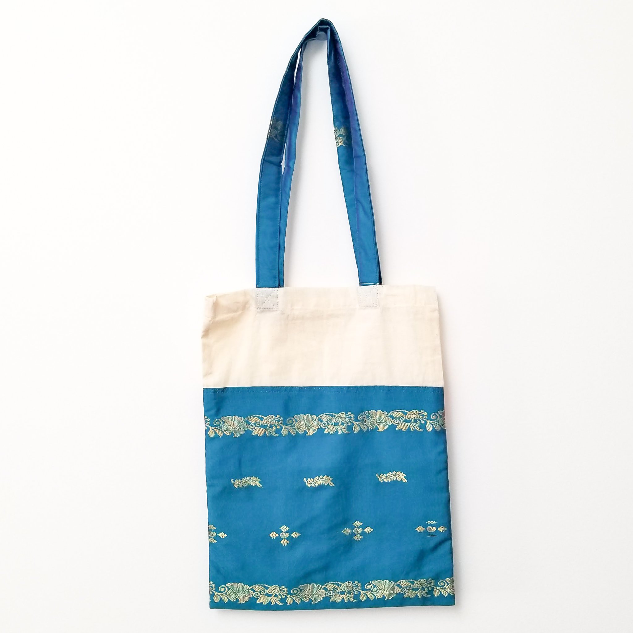 A vibrant Sari Tote Bag handcrafted from repurposed saris, showcasing unique patterns and colors, perfect for shopping and daily use.