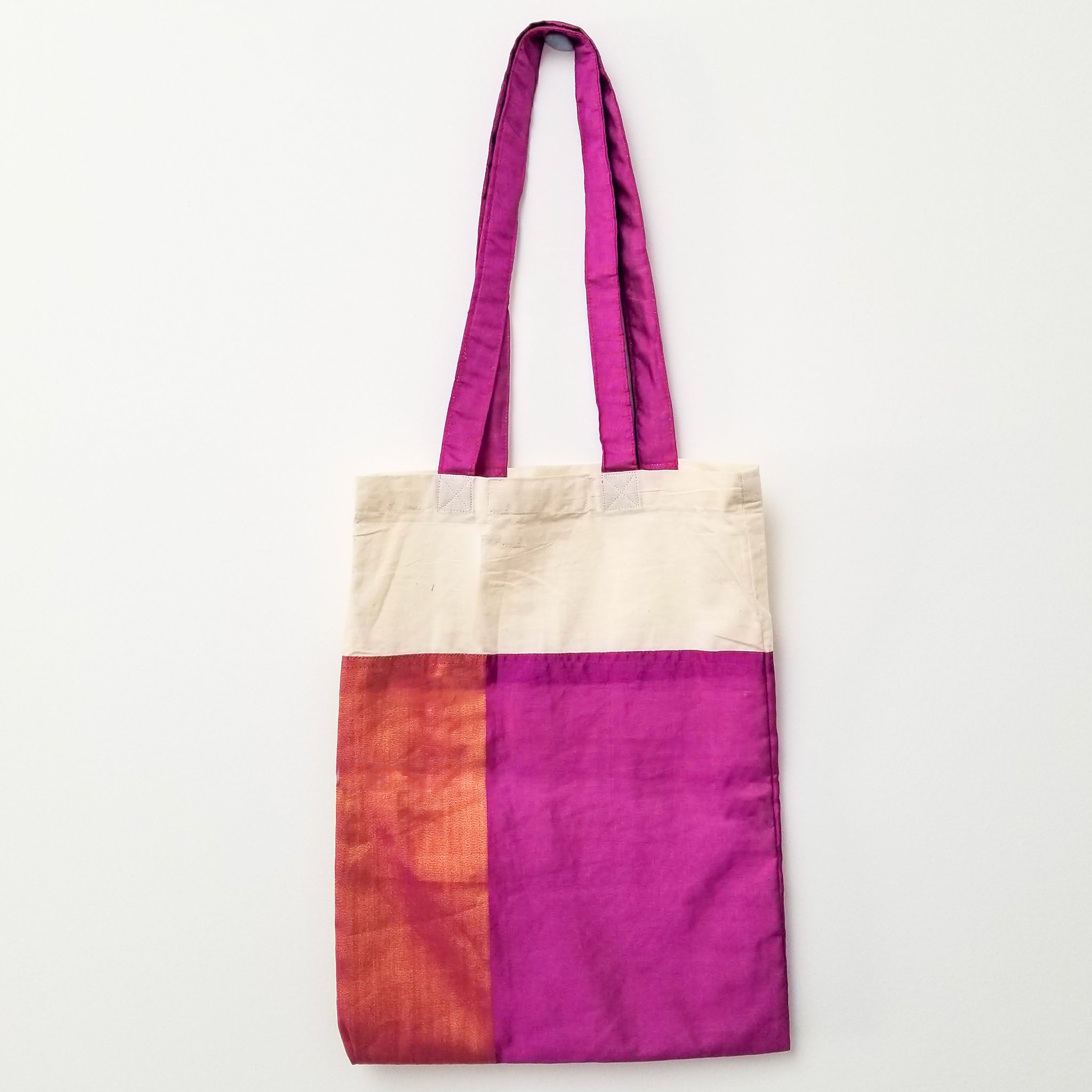 A vibrant Sari Tote Bag handcrafted from repurposed saris, showcasing unique patterns and colors, perfect for shopping and daily use.