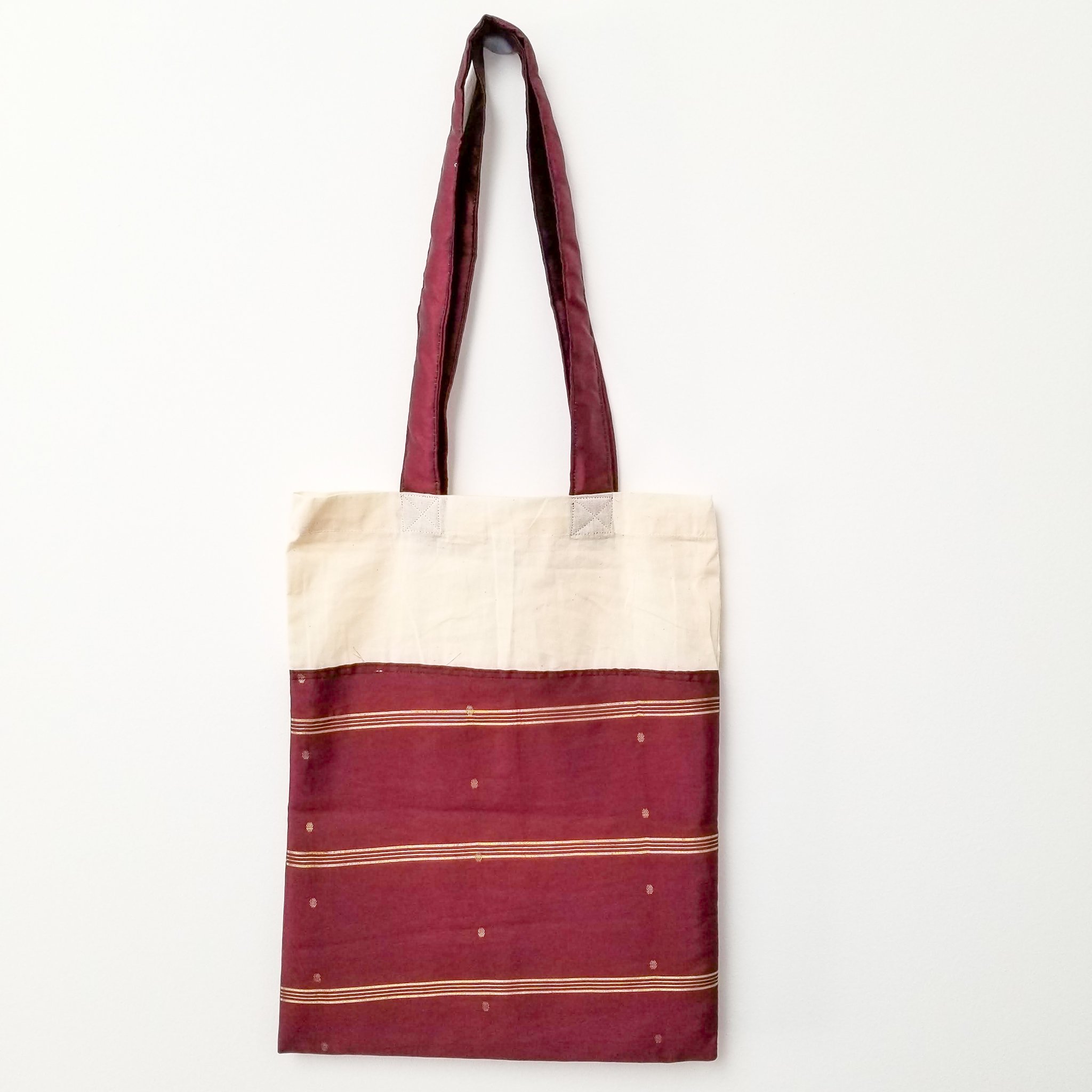 A vibrant Sari Tote Bag handcrafted from repurposed saris, showcasing unique patterns and colors, perfect for shopping and daily use.