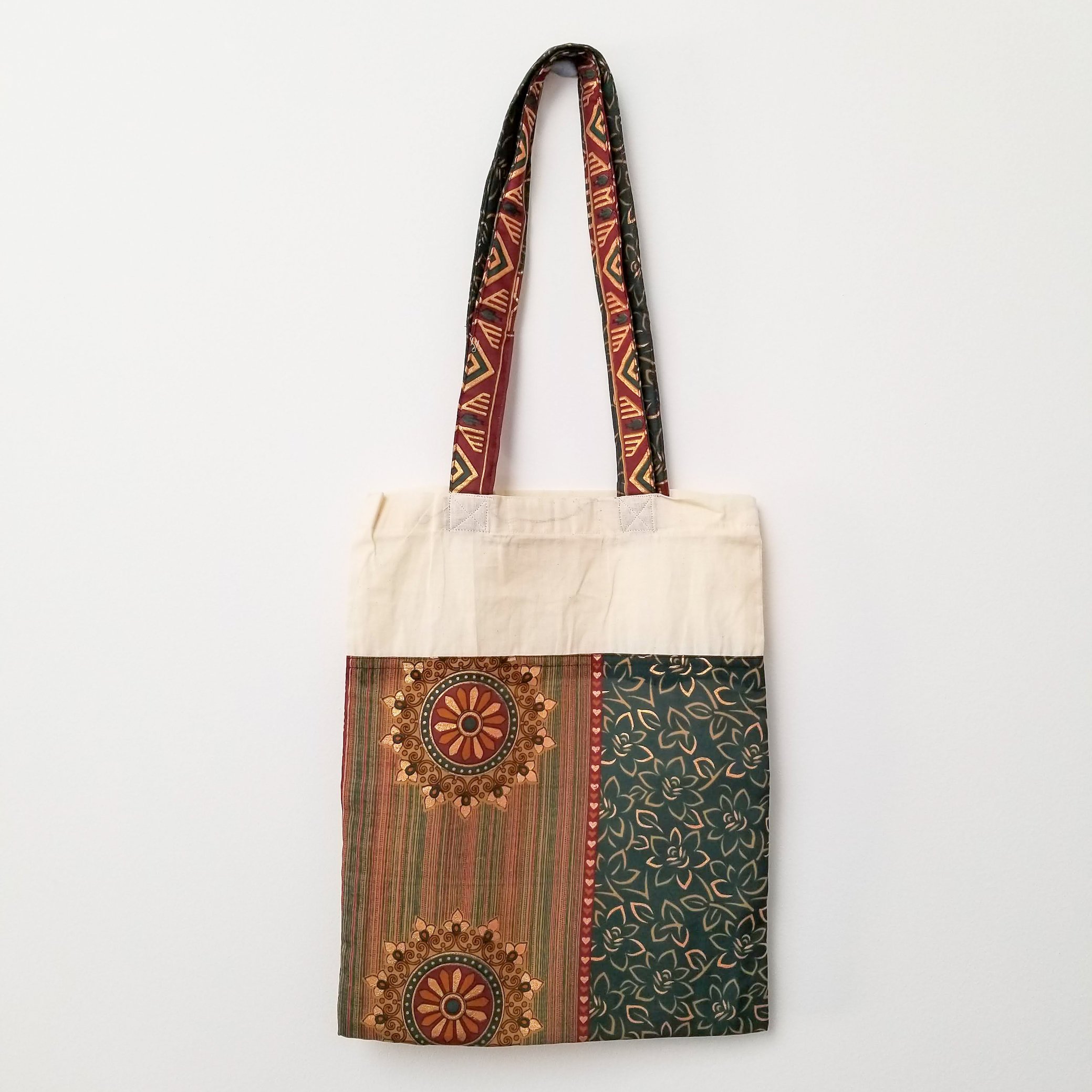 A vibrant Sari Tote Bag handcrafted from repurposed saris, showcasing unique patterns and colors, perfect for shopping and daily use.