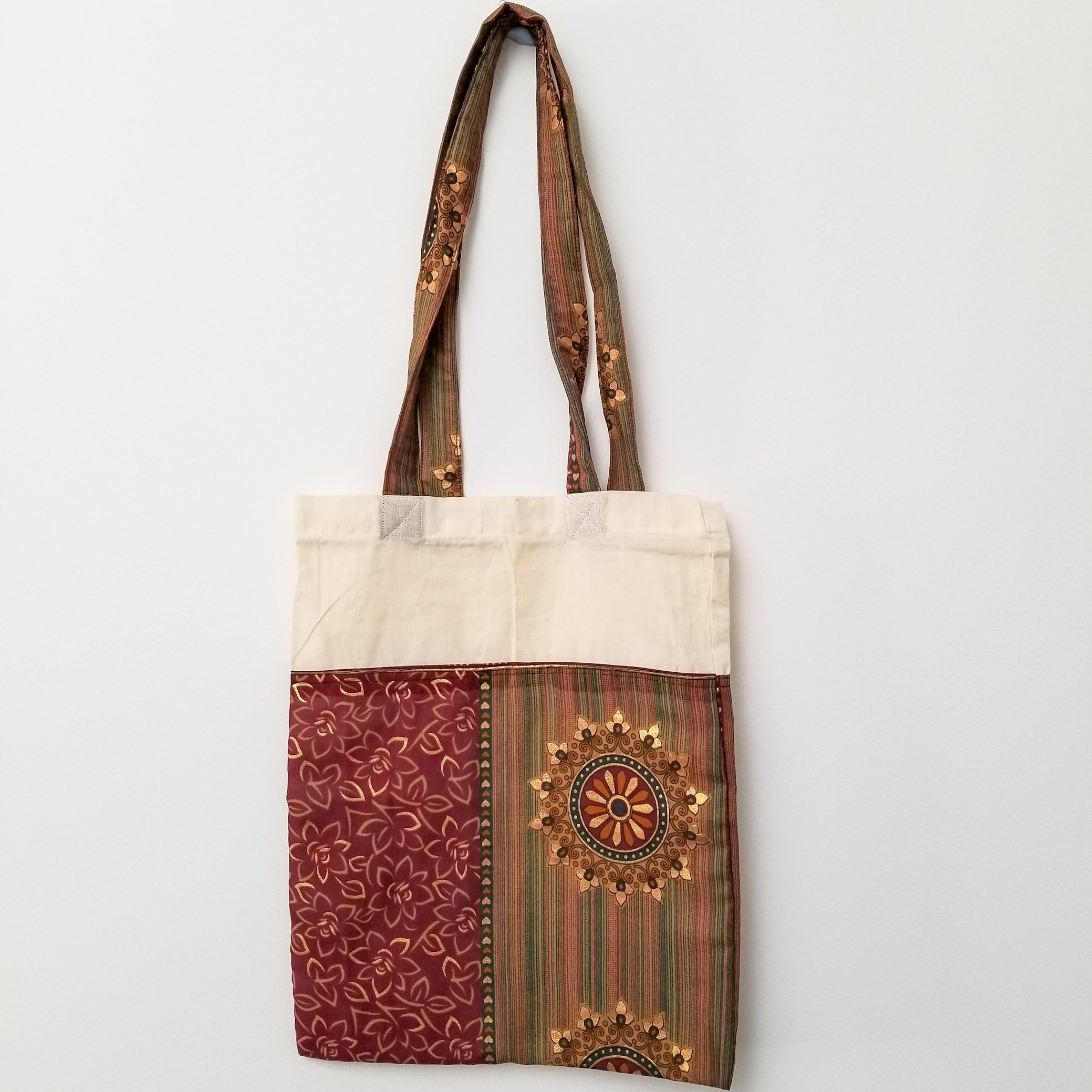 A vibrant Sari Tote Bag handcrafted from repurposed saris, showcasing unique patterns and colors, perfect for shopping and daily use.