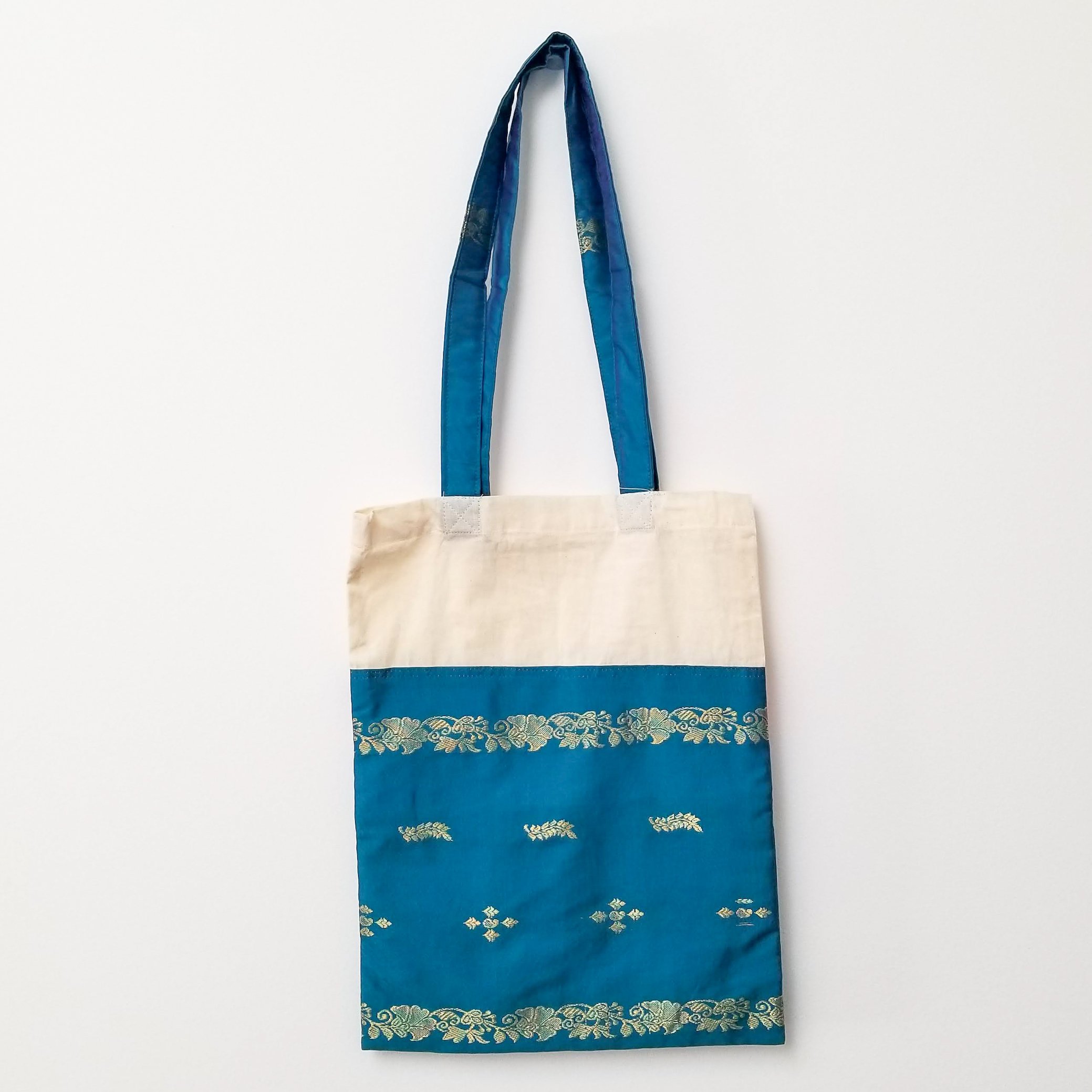 A vibrant Sari Tote Bag handcrafted from repurposed saris, showcasing unique patterns and colors, perfect for shopping and daily use.