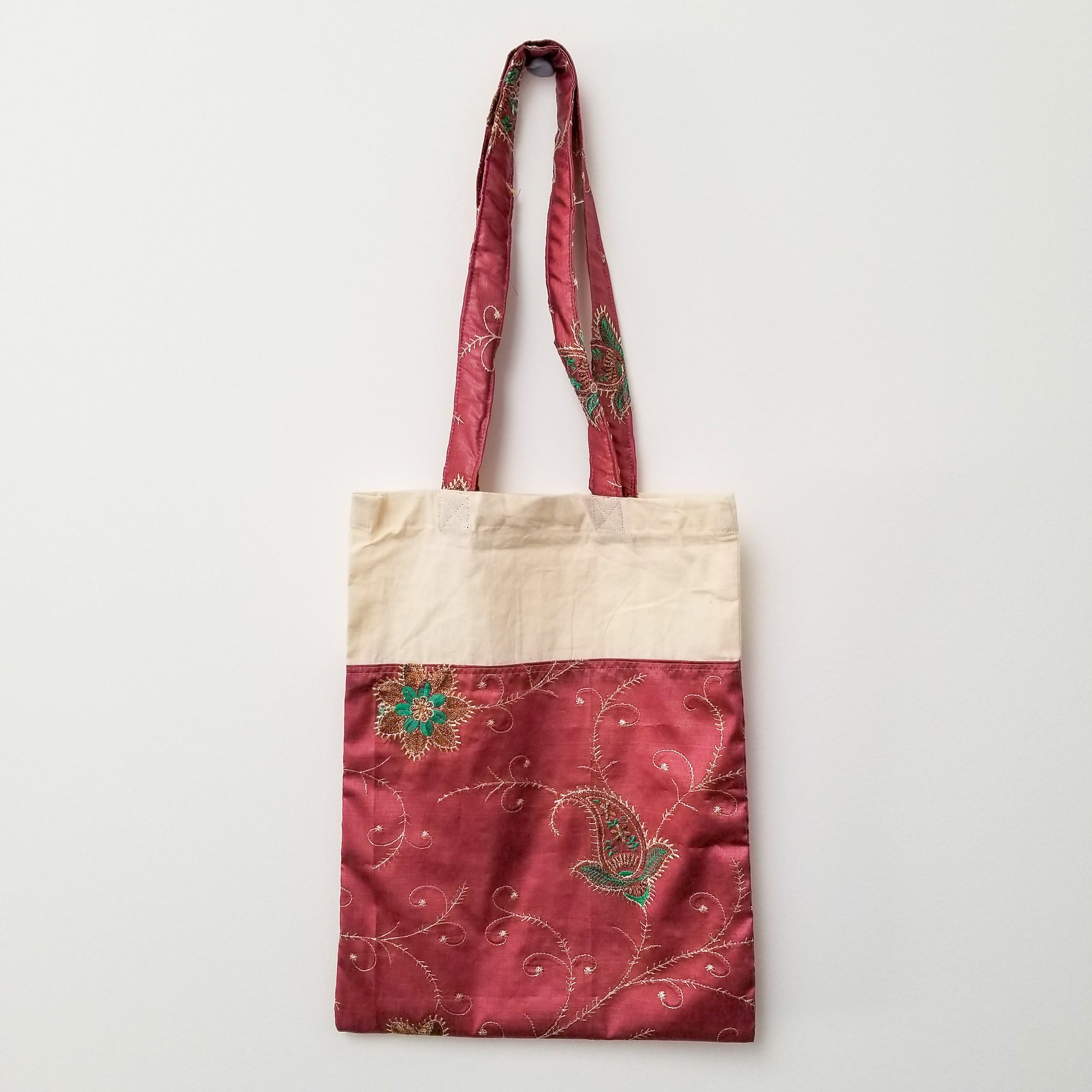 A vibrant Sari Tote Bag handcrafted from repurposed saris, showcasing unique patterns and colors, perfect for shopping and daily use.