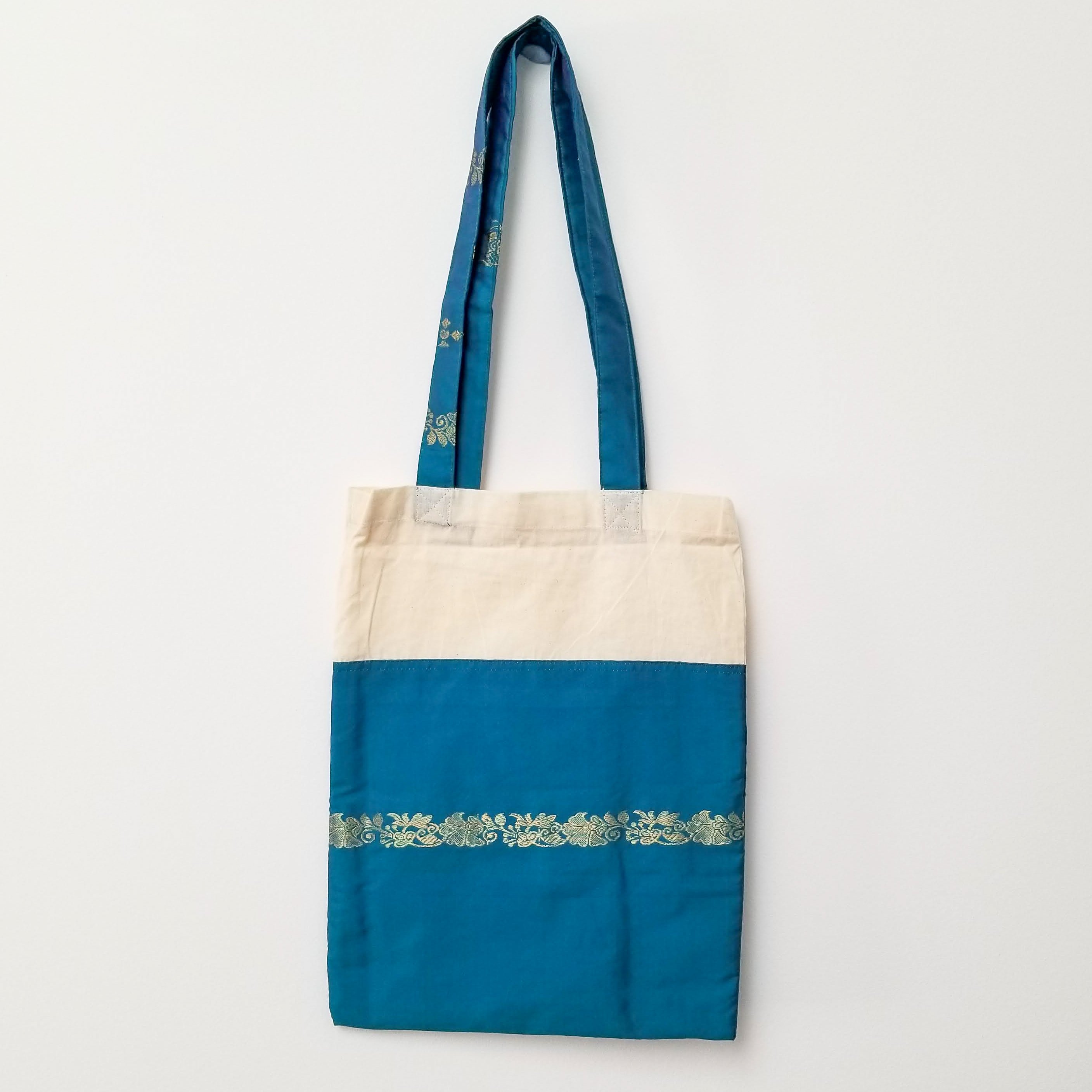 A vibrant Sari Tote Bag handcrafted from repurposed saris, showcasing unique patterns and colors, perfect for shopping and daily use.