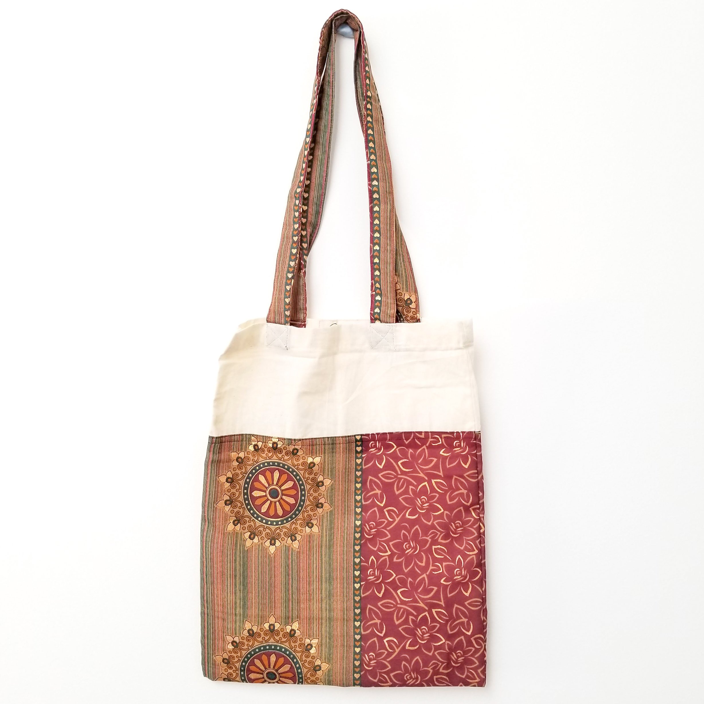 A vibrant Sari Tote Bag handcrafted from repurposed saris, showcasing unique patterns and colors, perfect for shopping and daily use.