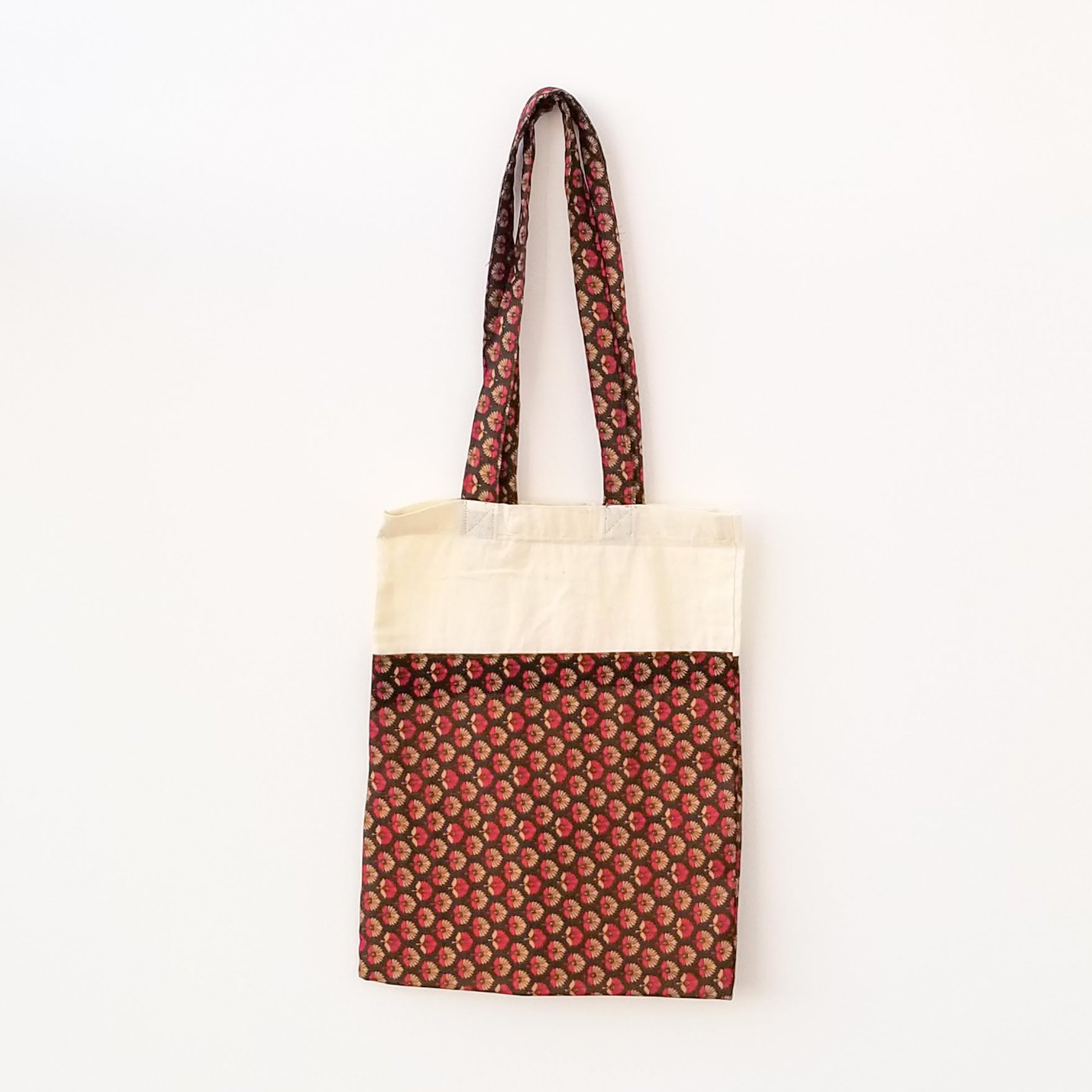 A vibrant Sari Tote Bag handcrafted from repurposed saris, showcasing unique patterns and colors, perfect for shopping and daily use.