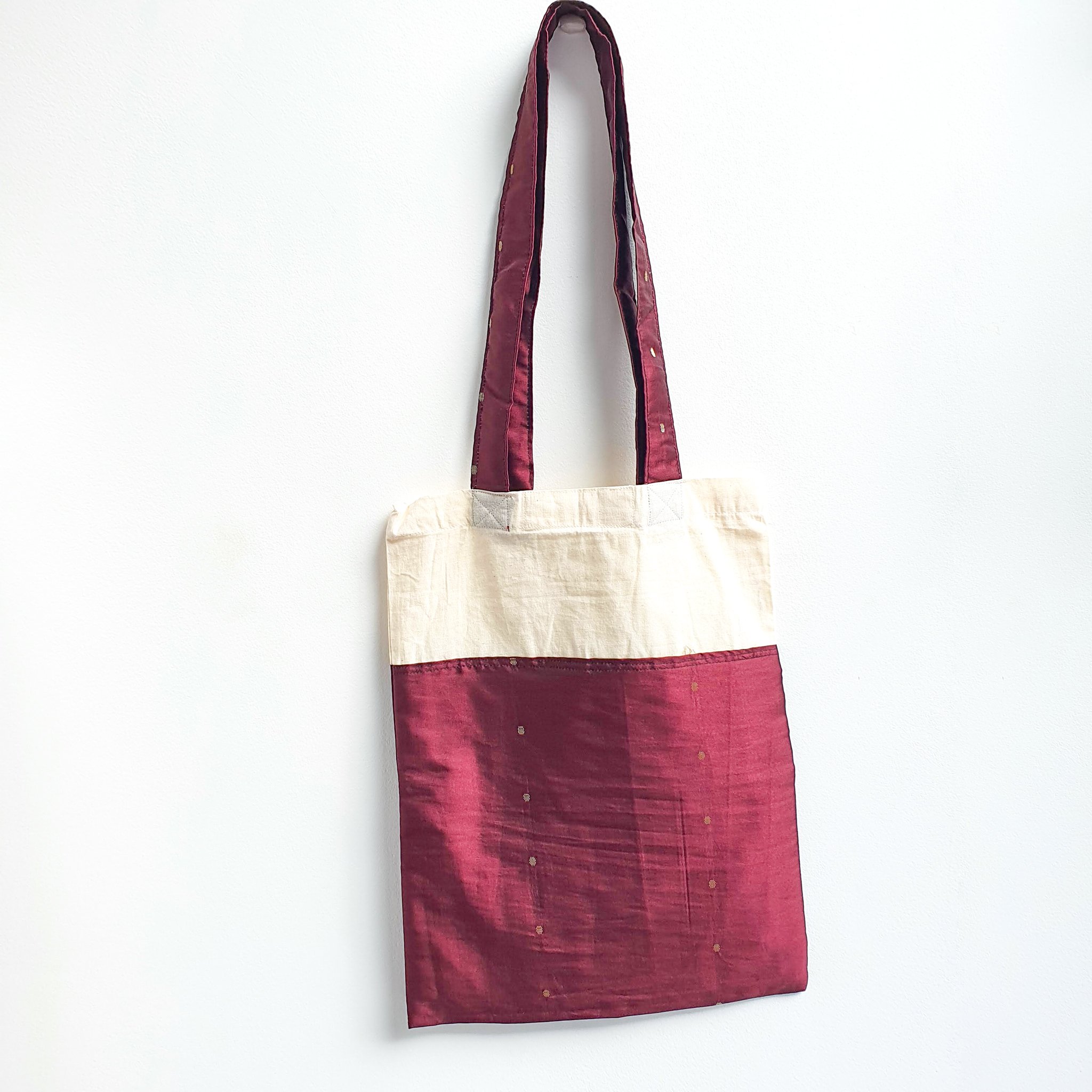 A vibrant Sari Tote Bag handcrafted from repurposed saris, showcasing unique patterns and colors, perfect for shopping and daily use.