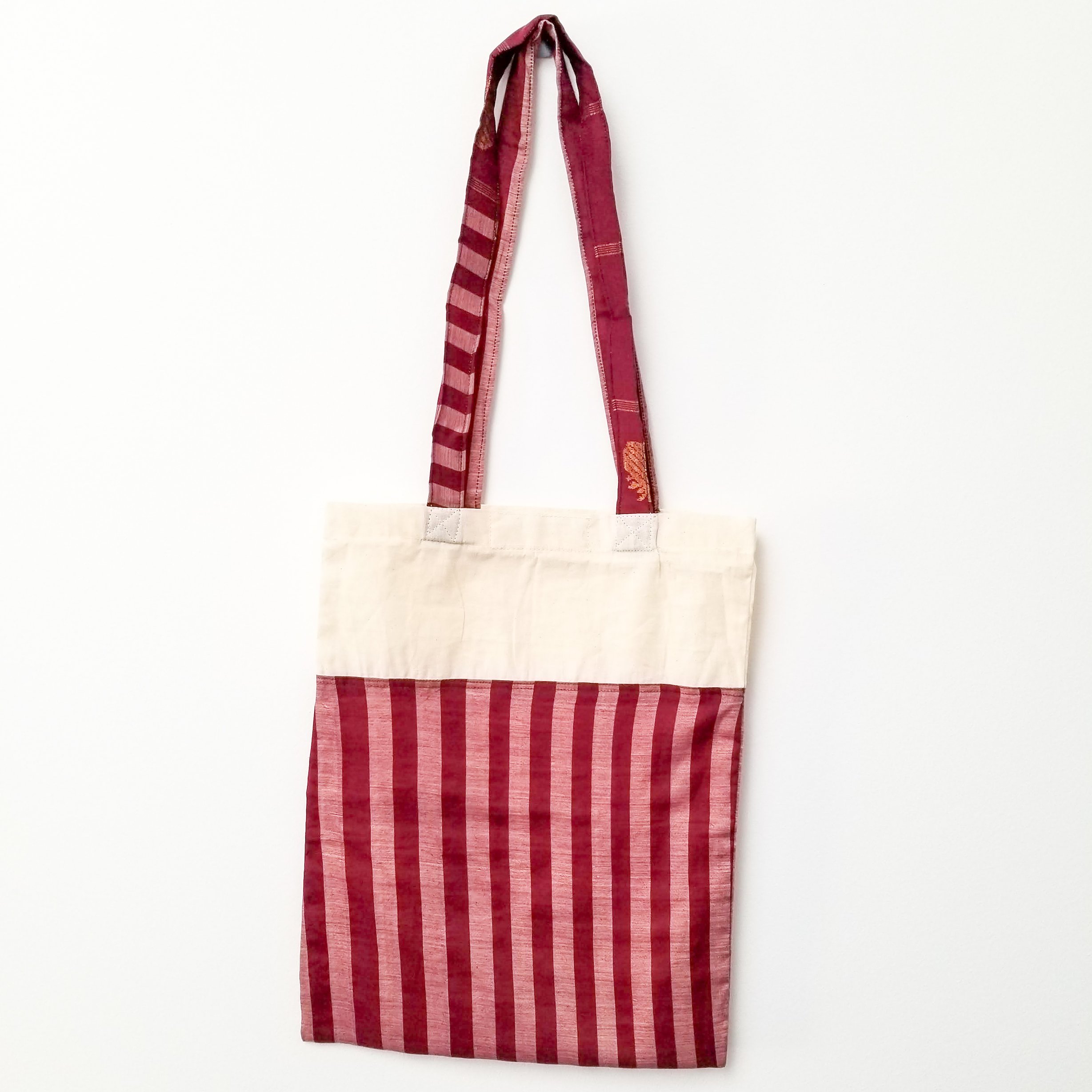 A vibrant Sari Tote Bag handcrafted from repurposed saris, showcasing unique patterns and colors, perfect for shopping and daily use.