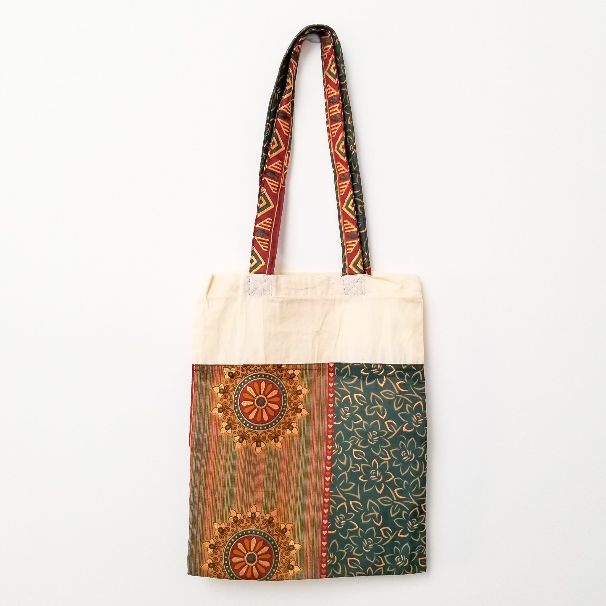 A vibrant Sari Tote Bag handcrafted from repurposed saris, showcasing unique patterns and colors, perfect for shopping and daily use.