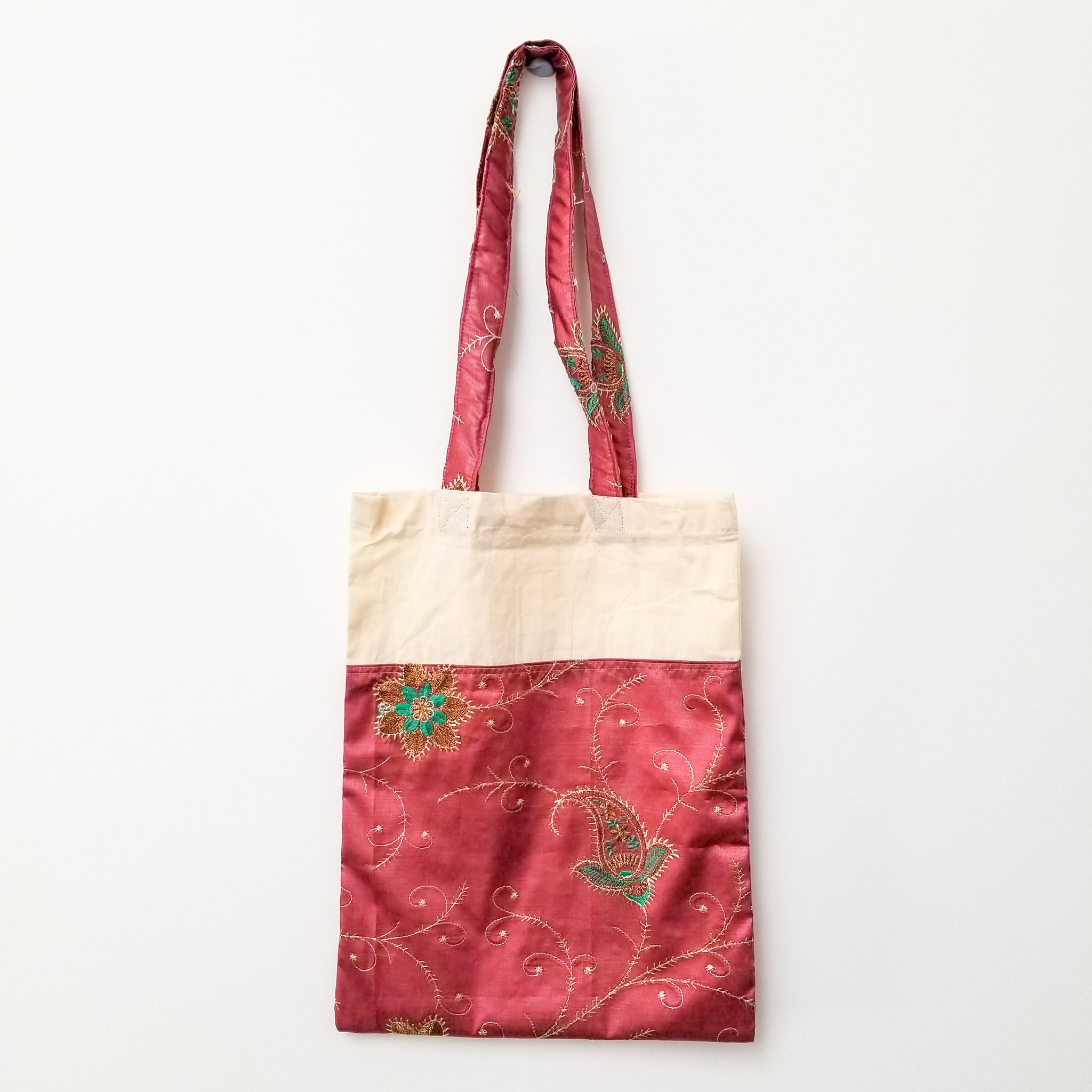 A vibrant Sari Tote Bag handcrafted from repurposed saris, showcasing unique patterns and colors, perfect for shopping and daily use.