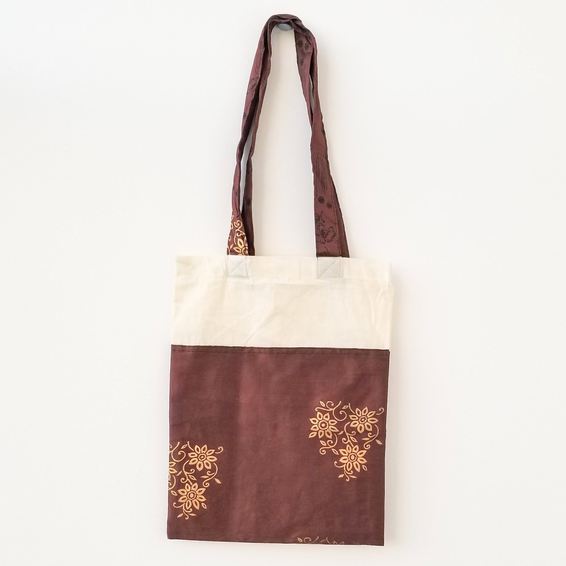 A vibrant Sari Tote Bag handcrafted from repurposed saris, showcasing unique patterns and colors, perfect for shopping and daily use.