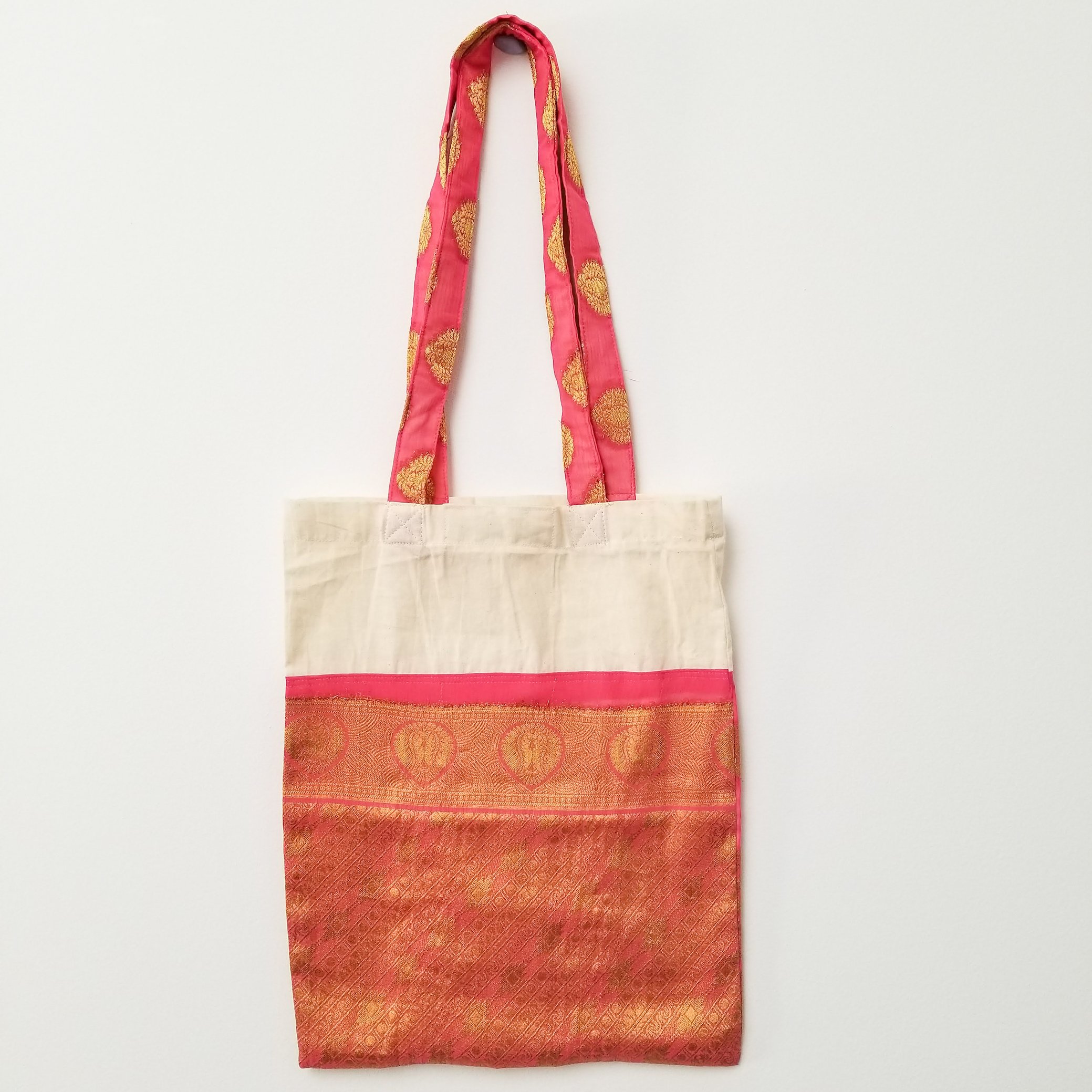 A vibrant Sari Tote Bag handcrafted from repurposed saris, showcasing unique patterns and colors, perfect for shopping and daily use.