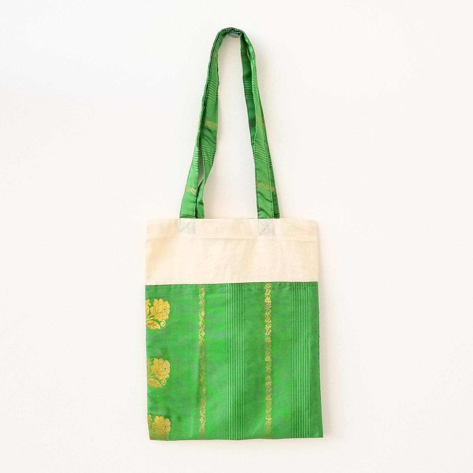 A vibrant Sari Tote Bag handcrafted from repurposed saris, showcasing unique patterns and colors, perfect for shopping and daily use.