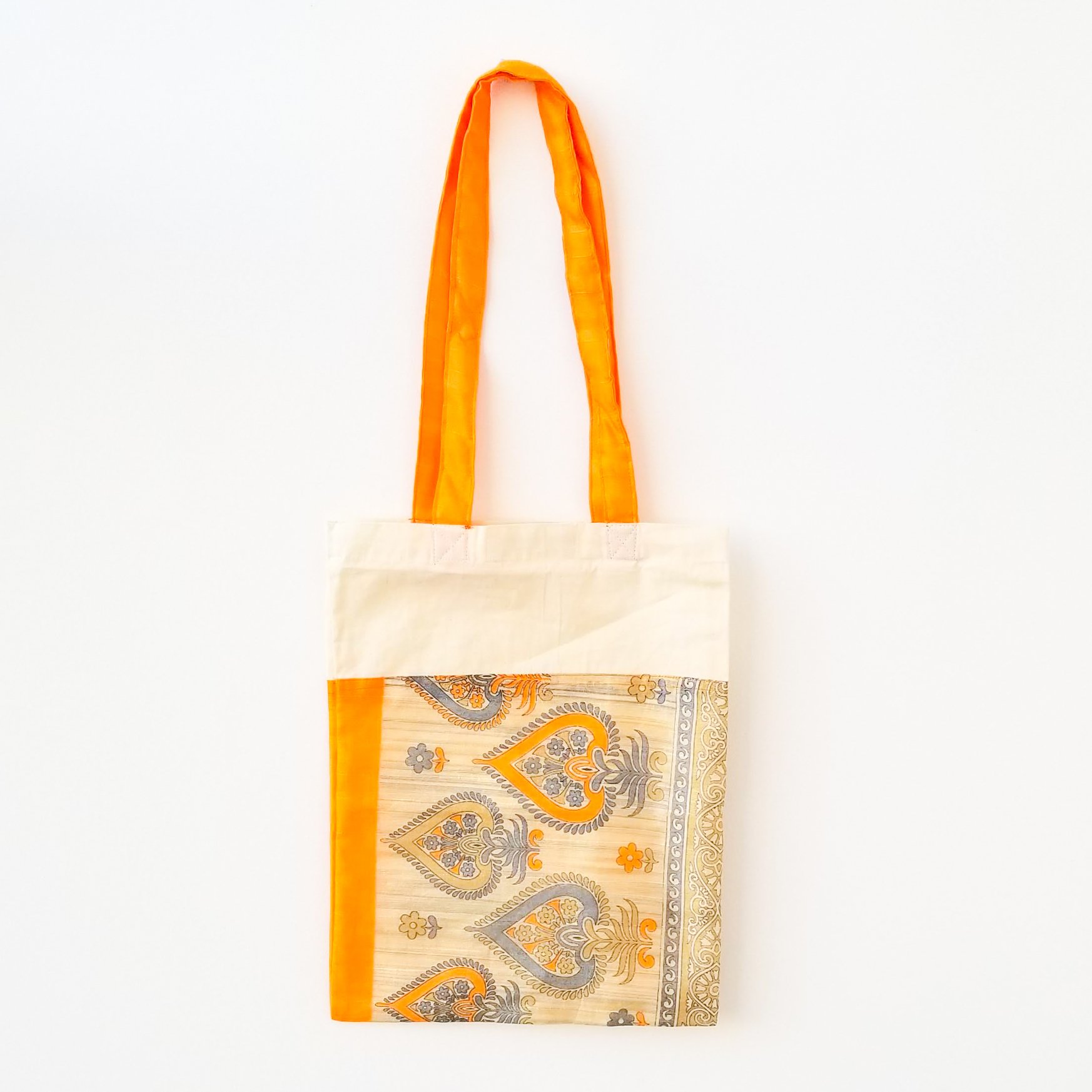 A vibrant Sari Tote Bag handcrafted from repurposed saris, showcasing unique patterns and colors, perfect for shopping and daily use.