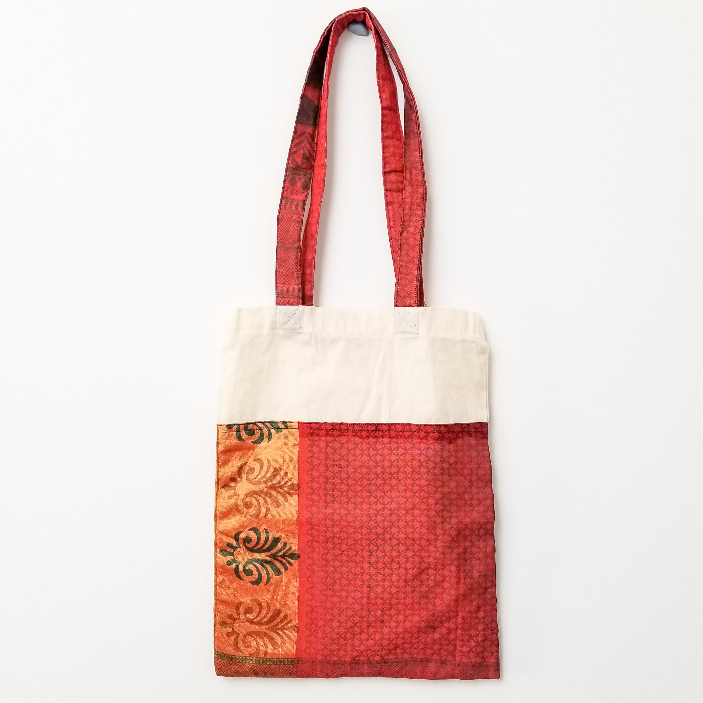 A vibrant Sari Tote Bag handcrafted from repurposed saris, showcasing unique patterns and colors, perfect for shopping and daily use.