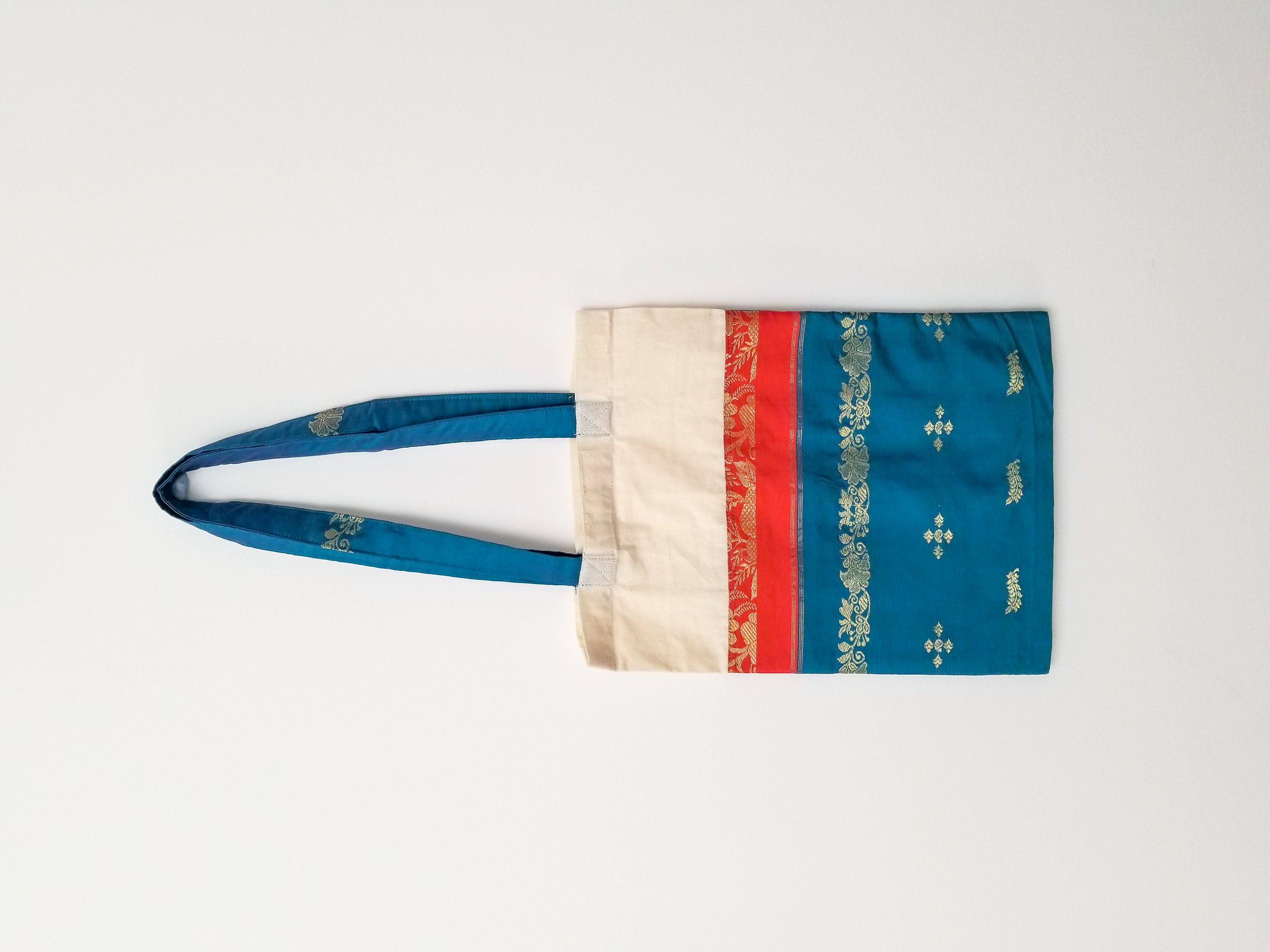 A vibrant Sari Tote Bag handcrafted from repurposed saris, showcasing unique patterns and colors, perfect for shopping and daily use.