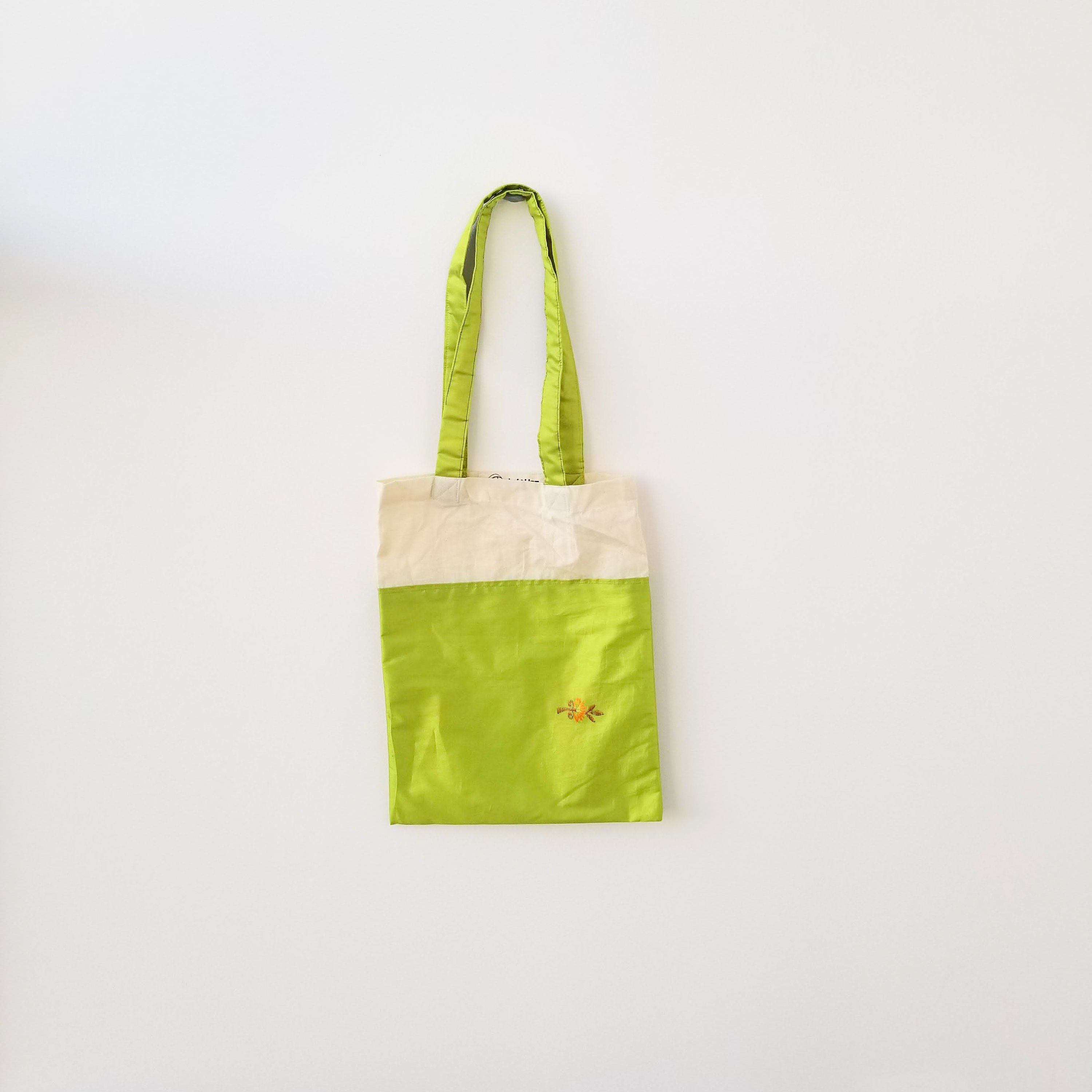 A vibrant Sari Tote Bag handcrafted from repurposed saris, showcasing unique patterns and colors, perfect for shopping and daily use.