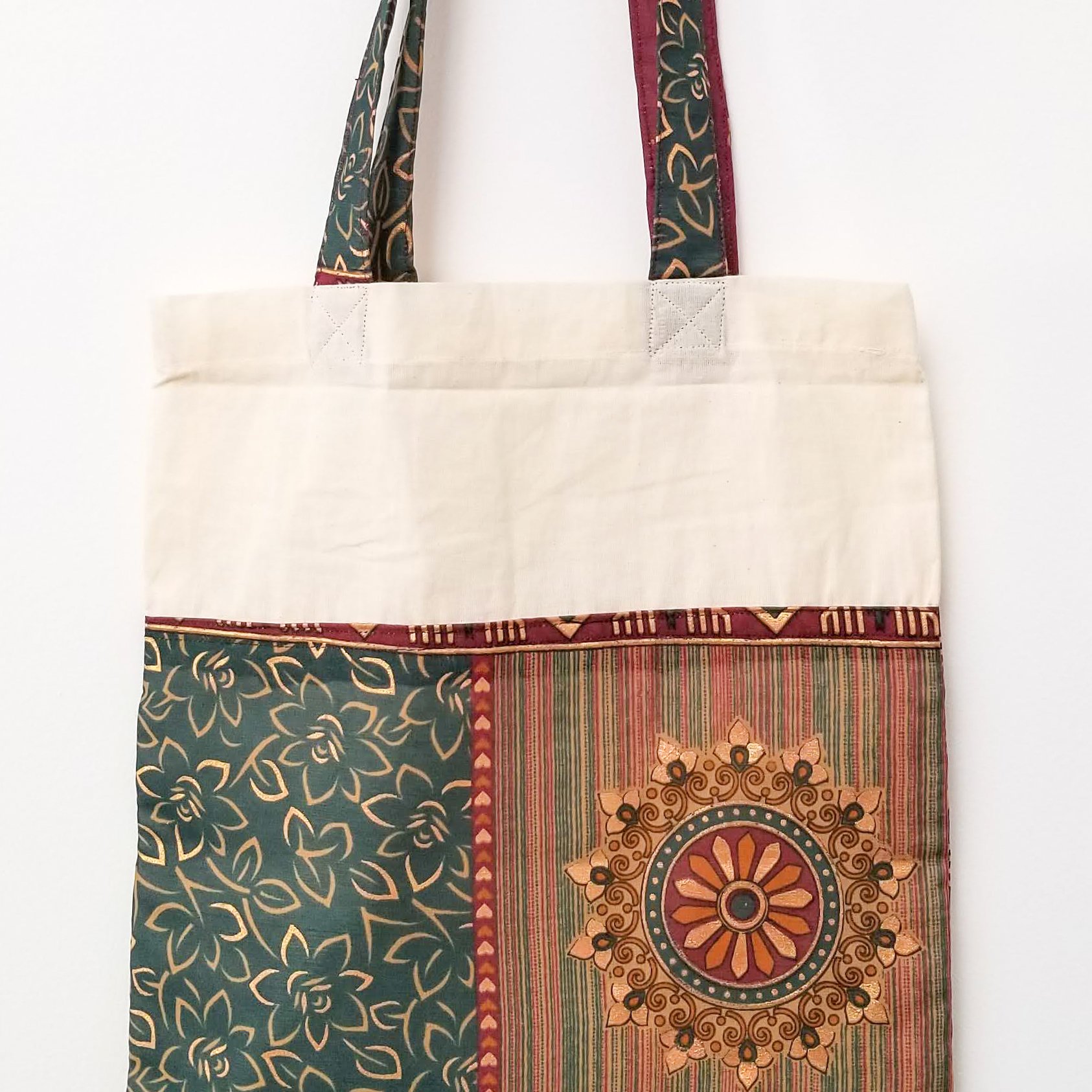 A vibrant Sari Tote Bag handcrafted from repurposed saris, showcasing unique patterns and colors, perfect for shopping and daily use.