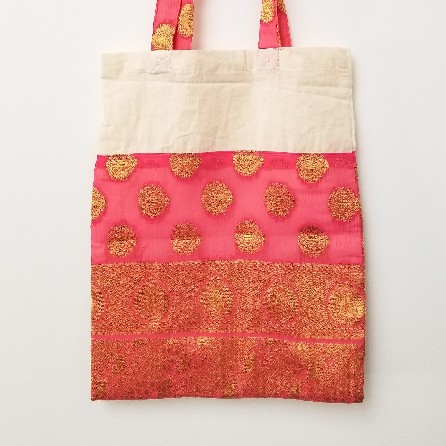 A vibrant Sari Tote Bag handcrafted from repurposed saris, showcasing unique patterns and colors, perfect for shopping and daily use.