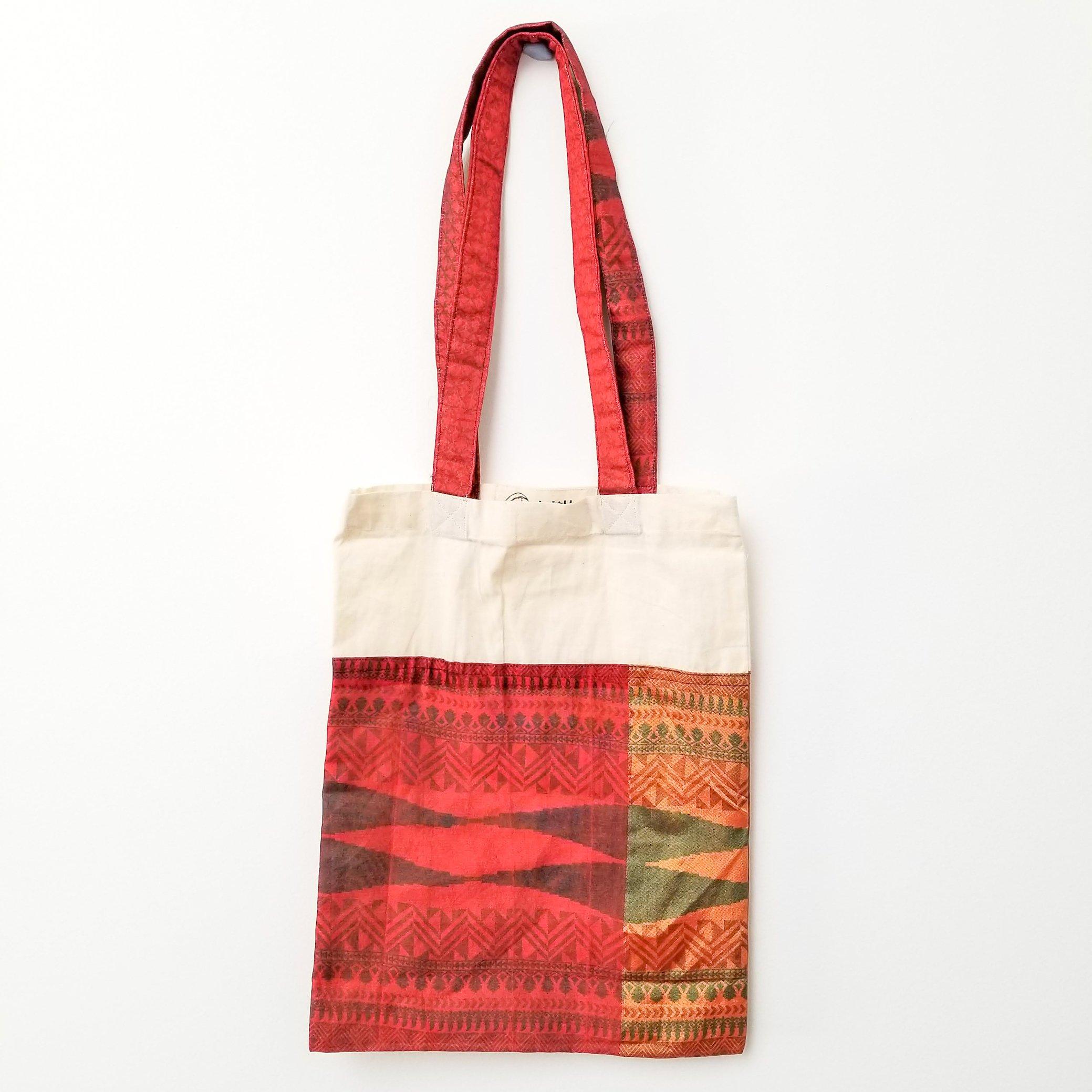 A vibrant Sari Tote Bag handcrafted from repurposed saris, showcasing unique patterns and colors, perfect for shopping and daily use.