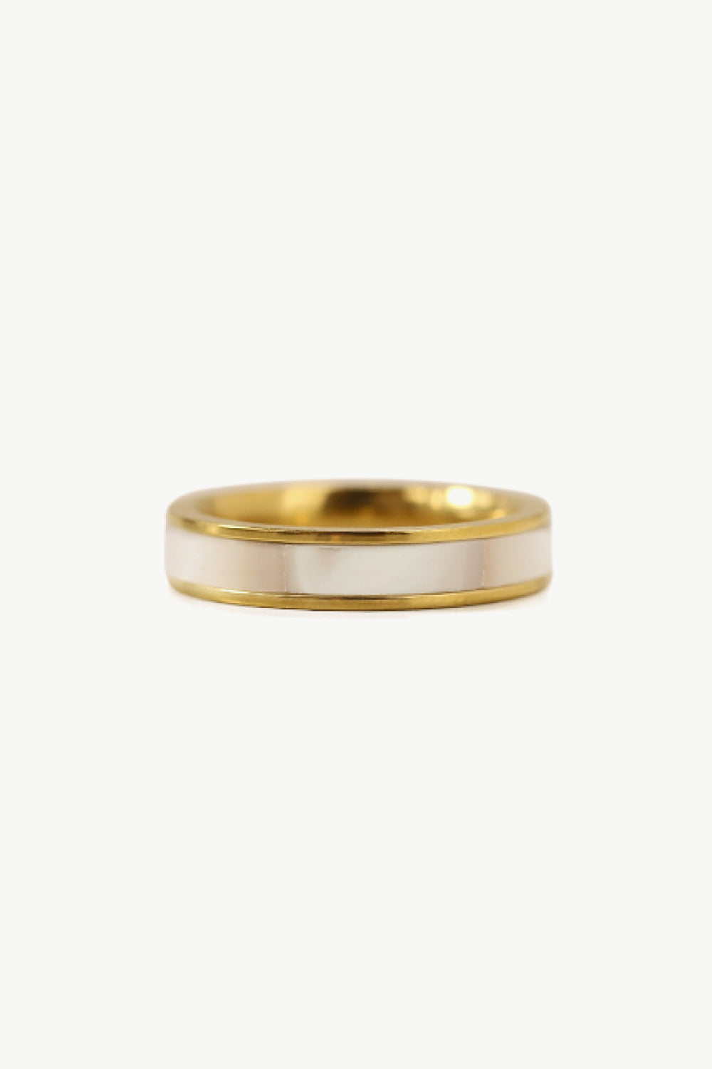 A stylish Shell Gold-Plated Ring featuring natural shell accents and a titanium steel base, elegantly displayed on a ghost mannequin.