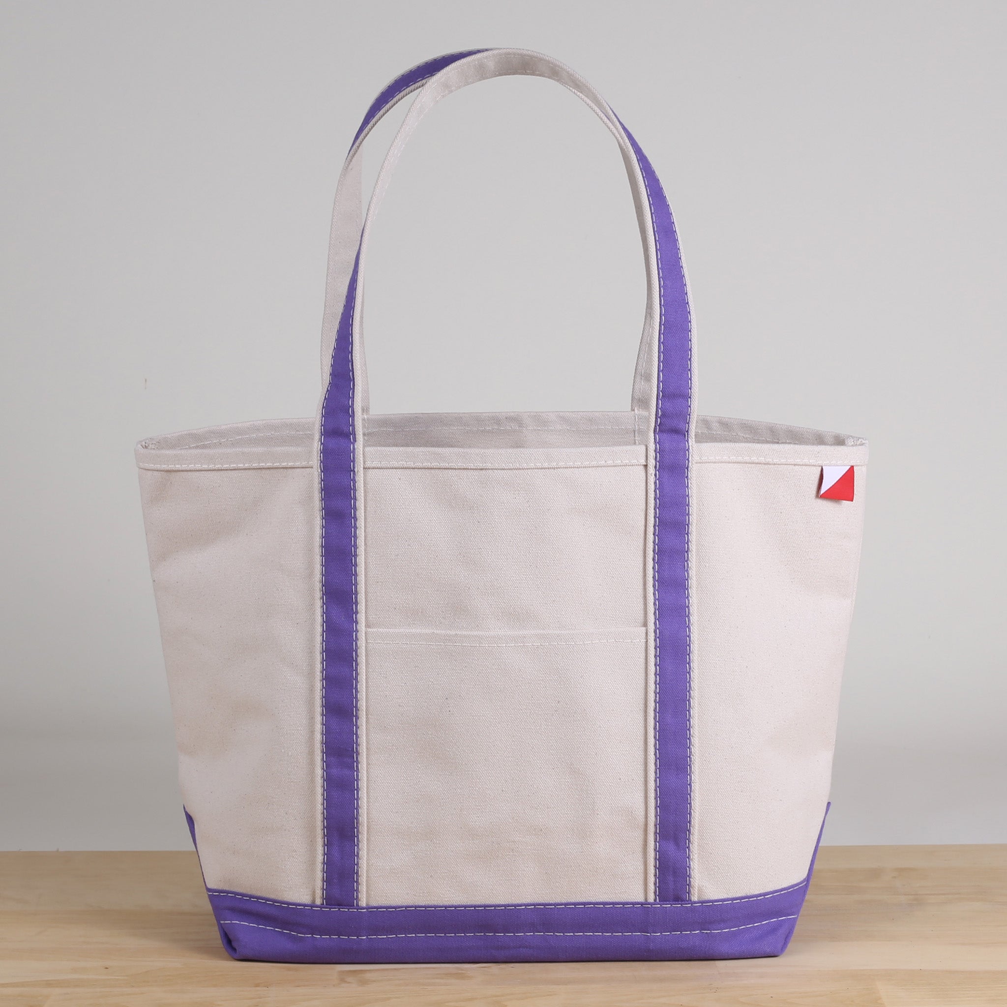 ShoreBags Classic Tote Medium in vibrant colors with double bottom and reinforced handles, showcasing its spacious interior and 360-degree pockets.