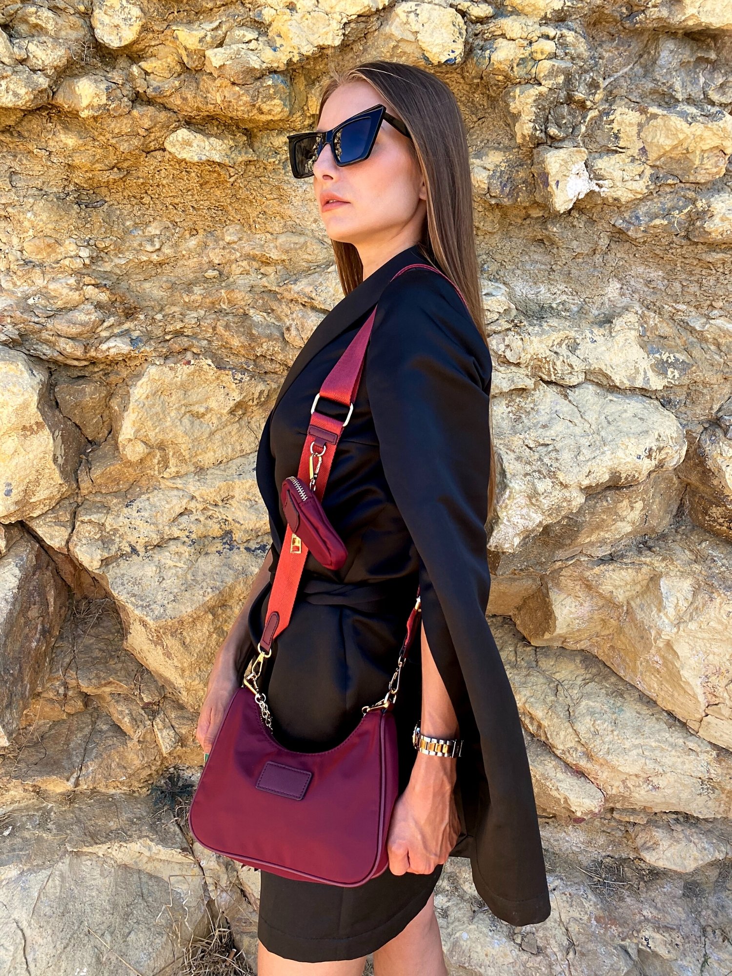 Stylish shoulder bag in magenta and beige with adjustable strap and zip closure, featuring a lined interior and zip pocket.