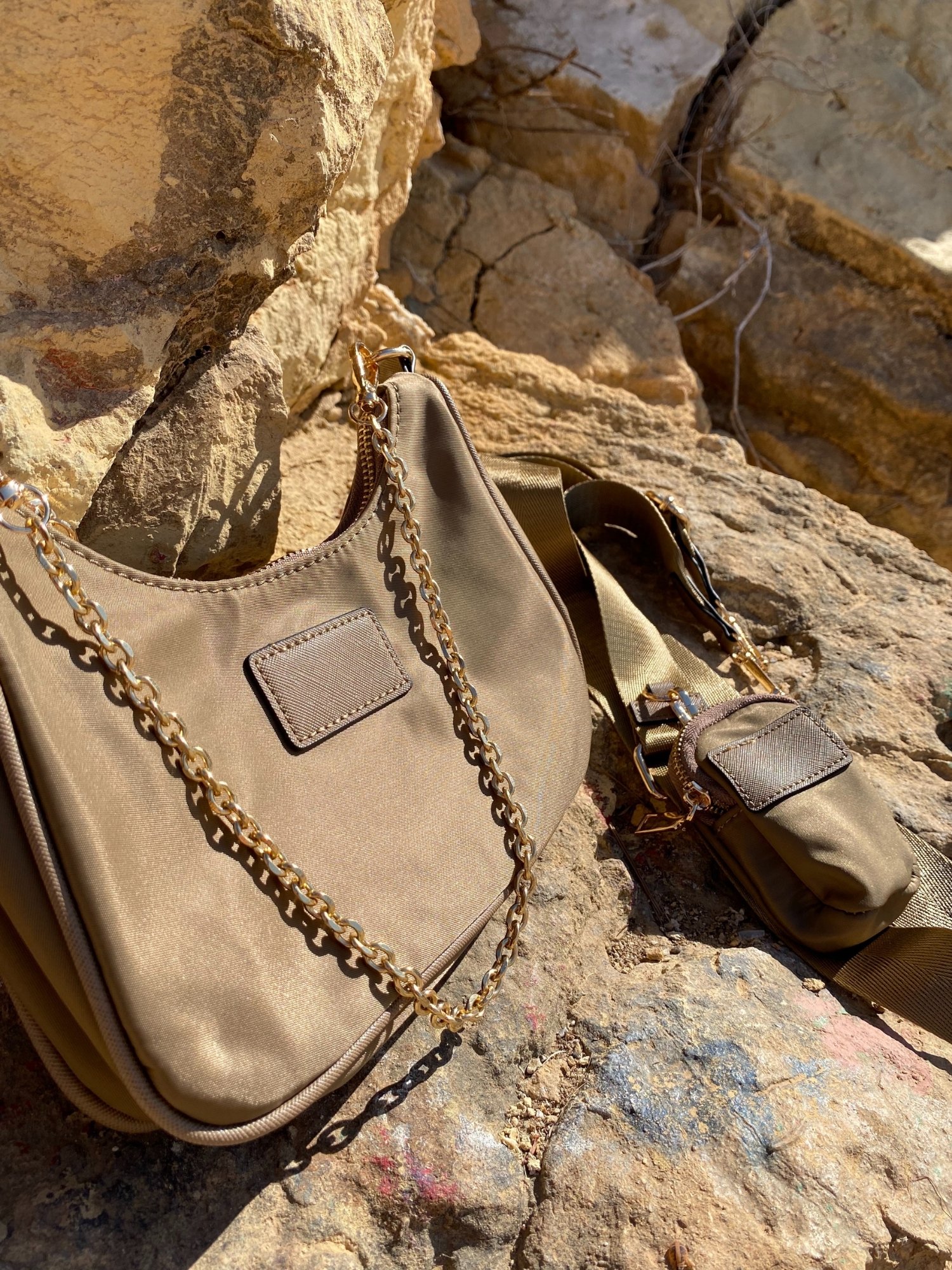 Stylish shoulder bag in magenta and beige with adjustable strap and zip closure, featuring a lined interior and zip pocket.