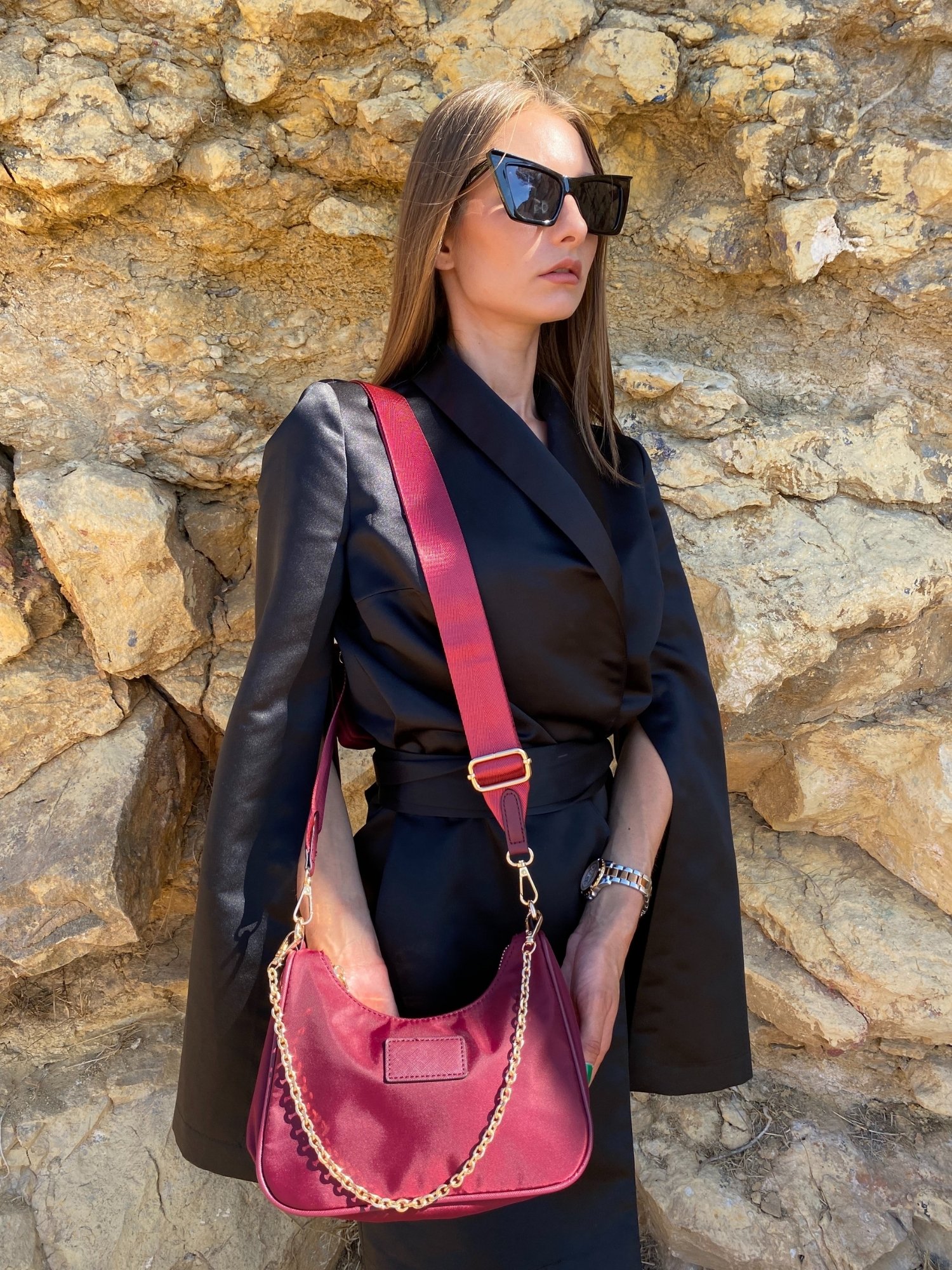 Stylish shoulder bag in magenta and beige with adjustable strap and zip closure, featuring a lined interior and zip pocket.