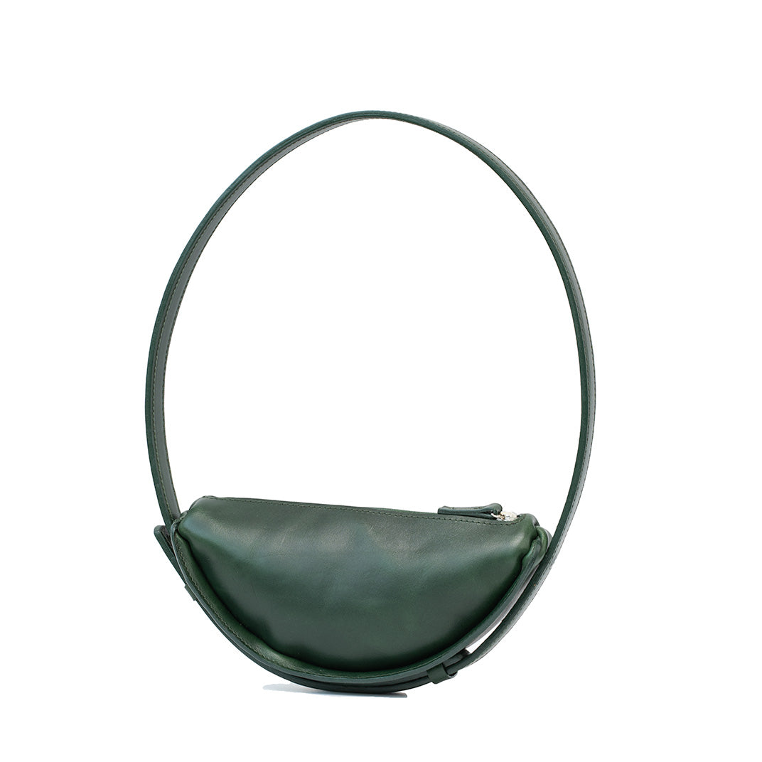 Thales Shoulder Bag in Forest Green, handcrafted leather with a unique crescent shape, showcasing its spacious interior and premium craftsmanship.