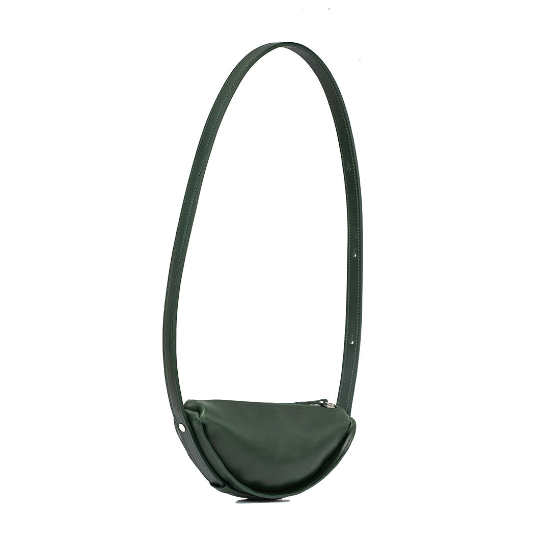 Thales Shoulder Bag in Forest Green, handcrafted leather with a unique crescent shape, showcasing its spacious interior and premium craftsmanship.