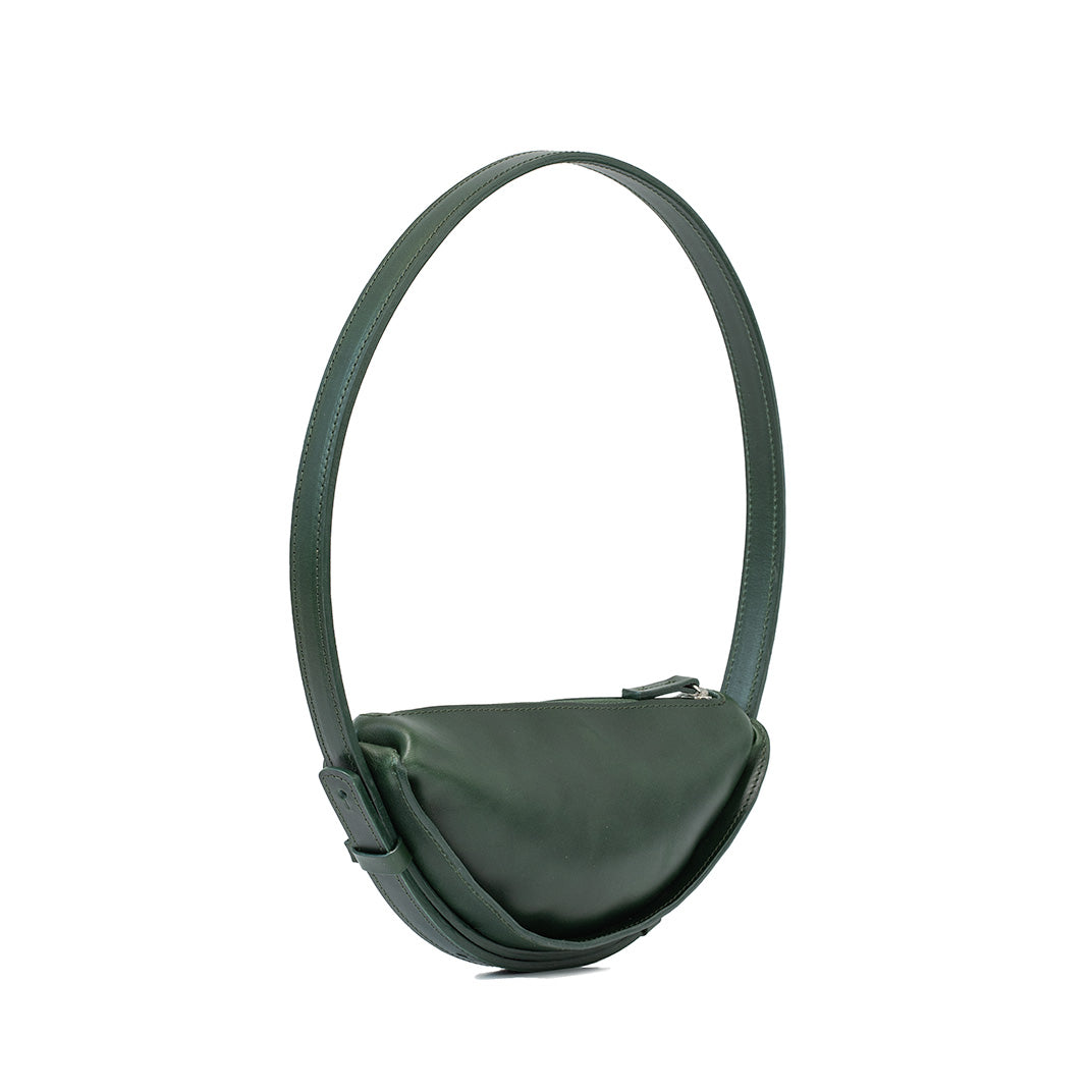 Thales Shoulder Bag in Forest Green, handcrafted leather with a unique crescent shape, showcasing its spacious interior and premium craftsmanship.