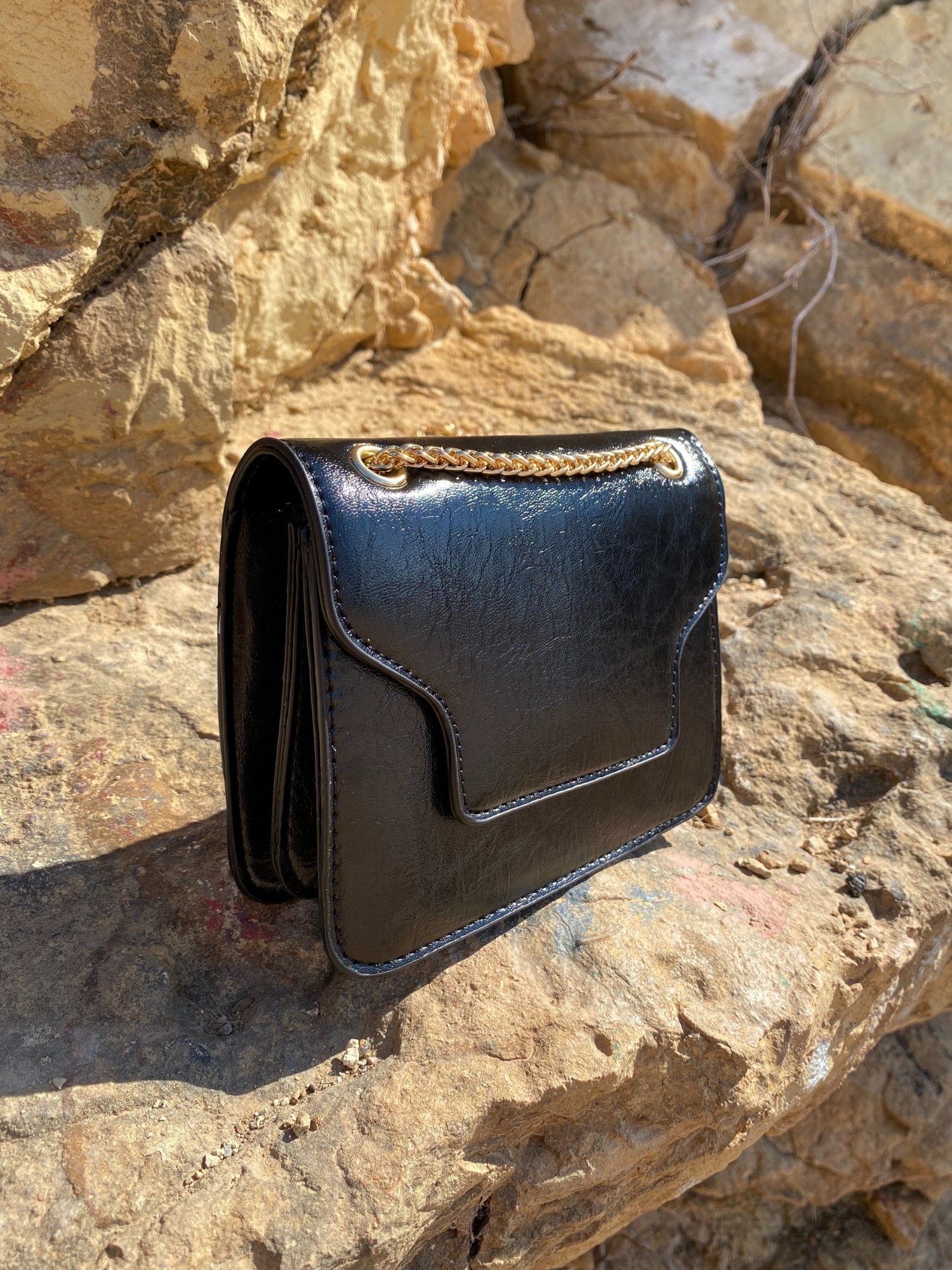 A stylish black Shoulder Mini Bag made of synthetic leather with a chain-link shoulder strap and magnetic closure.