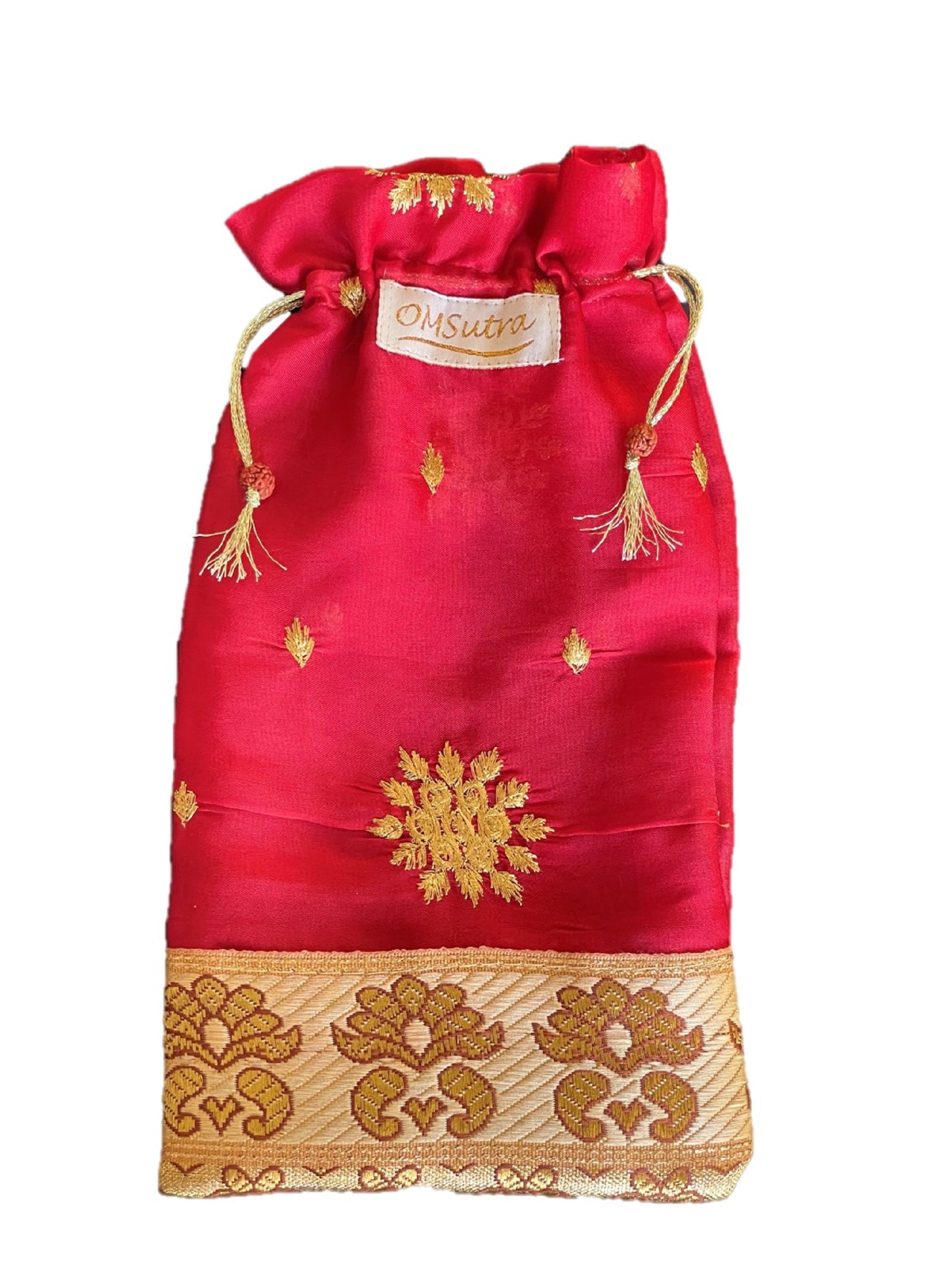 A beautifully handcrafted silk gift bag from Varanasi, India, showcasing intricate stitching and vibrant colors.