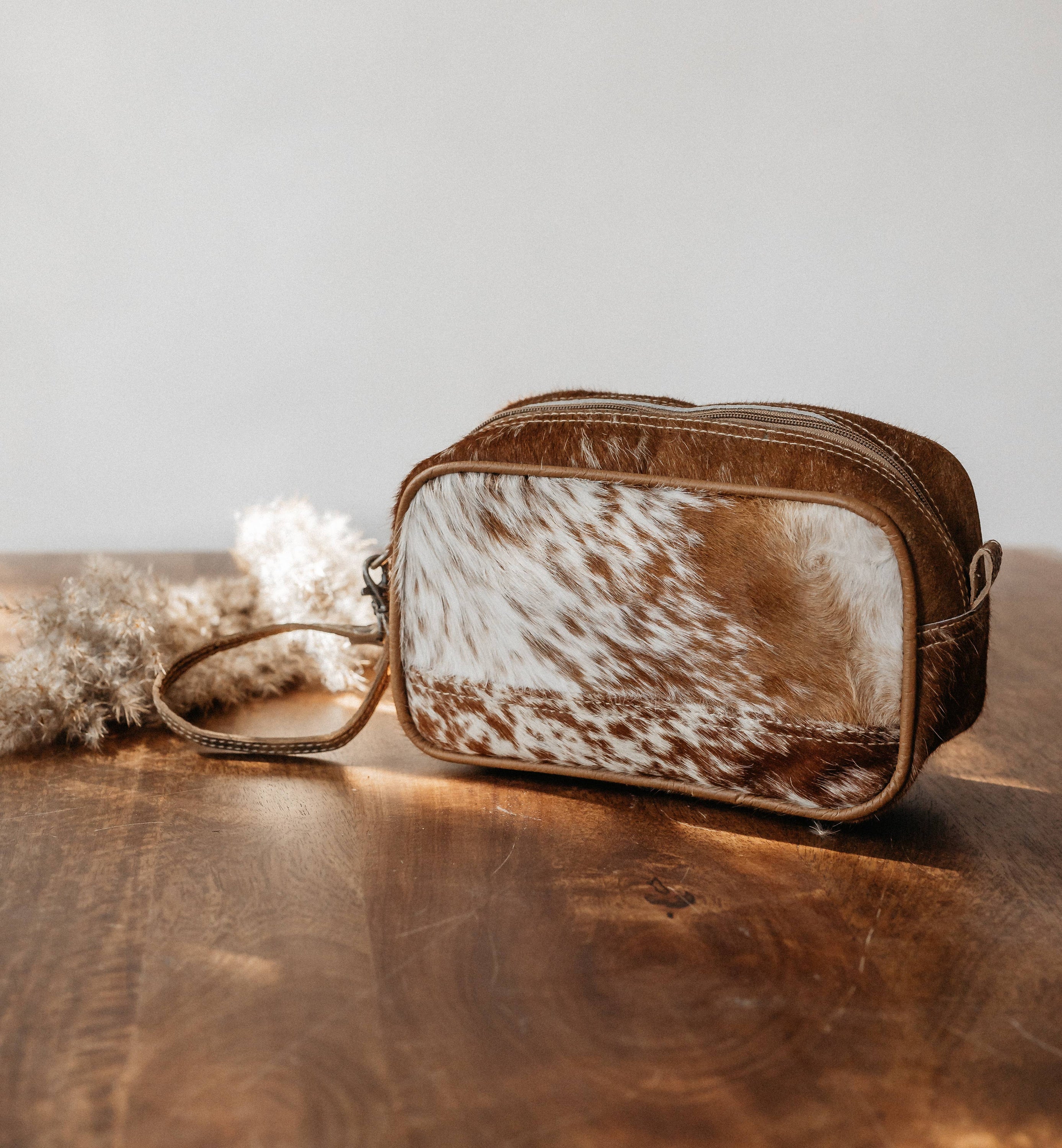 Skye Dopp Kit made of hairon and leather, showcasing its stylish design and durable construction.