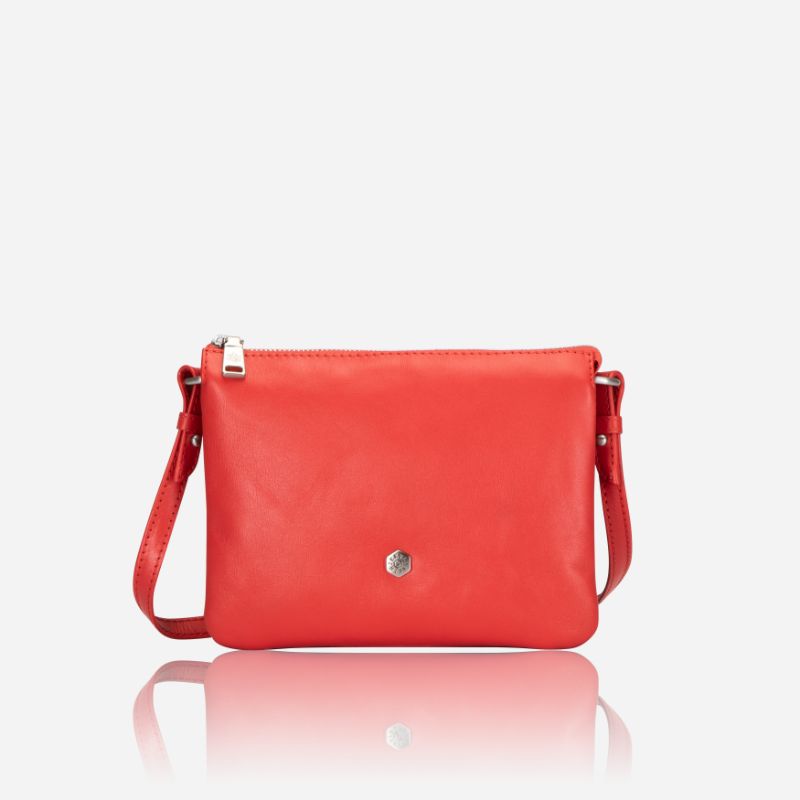 Slim Ladies Leather Crossbody handbag in vibrant candy apple color, showcasing its sleek design and adjustable strap.