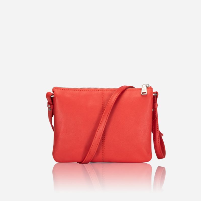 Slim Ladies Leather Crossbody handbag in vibrant candy apple color, showcasing its sleek design and adjustable strap.