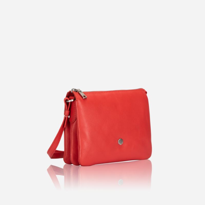 Slim Ladies Leather Crossbody handbag in vibrant candy apple color, showcasing its sleek design and adjustable strap.