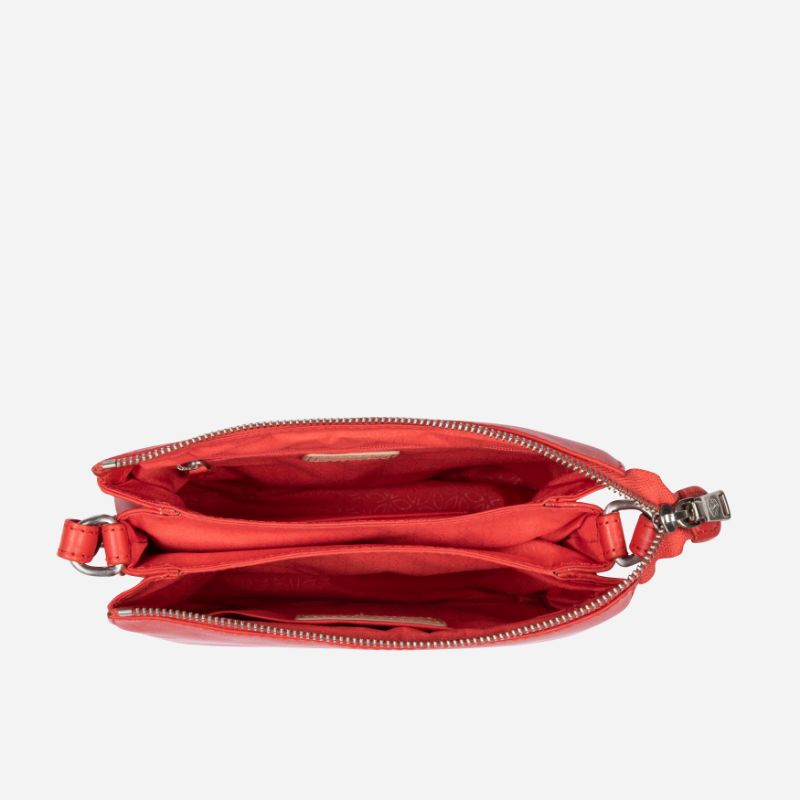 Slim Ladies Leather Crossbody handbag in vibrant candy apple color, showcasing its sleek design and adjustable strap.