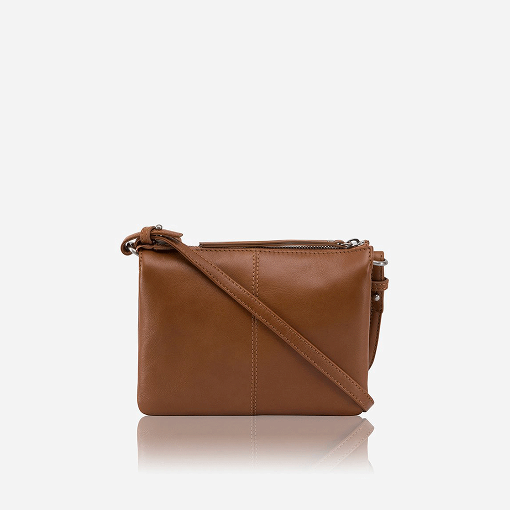 Slim Ladies Leather Crossbody bag in tan color, showcasing its stylish design and adjustable strap.