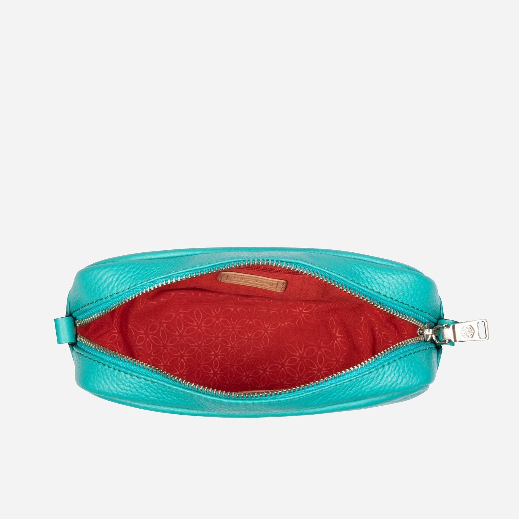 Small Crossbody bag in Calypso Teal with vibrant lining and adjustable strap.