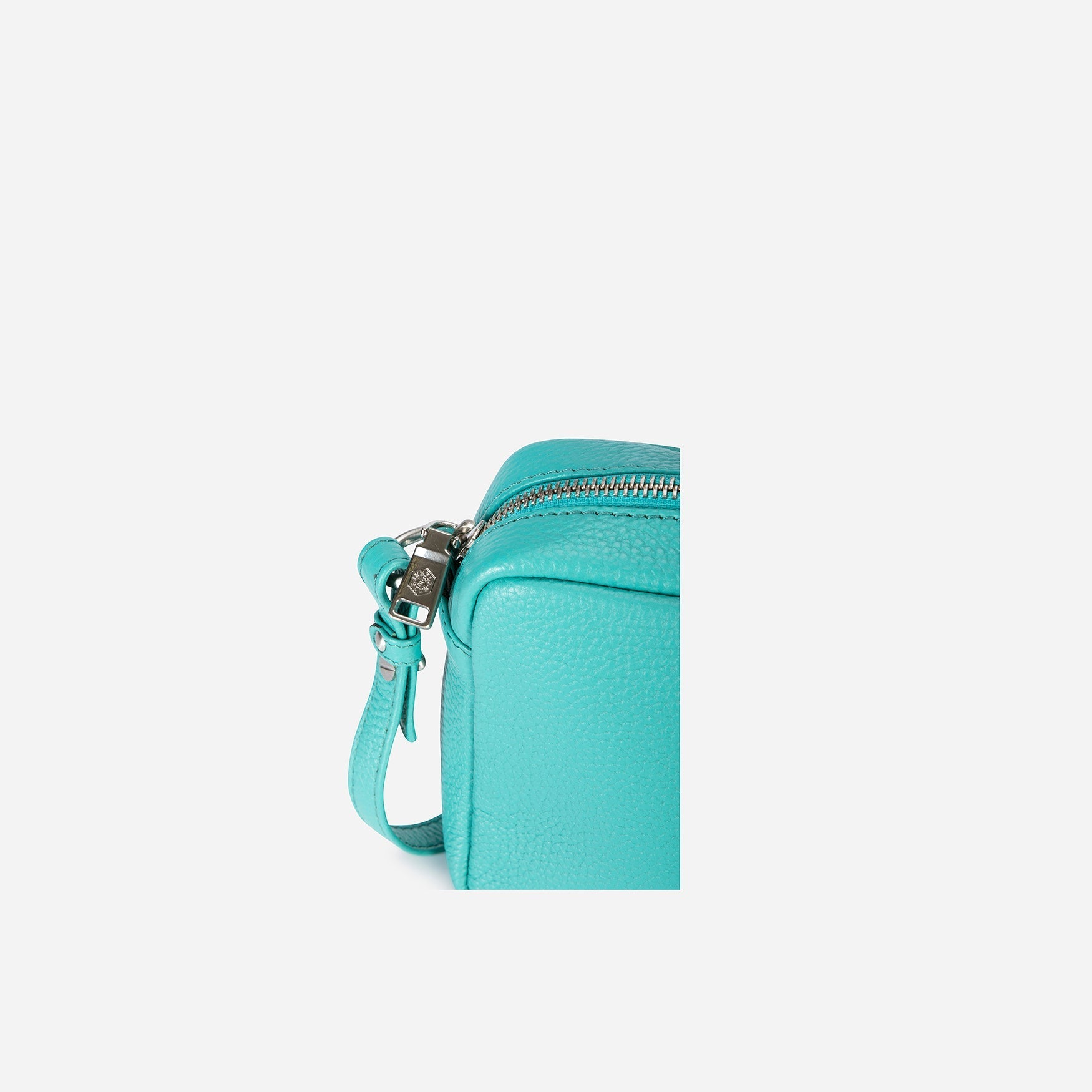 Small Crossbody bag in Calypso Teal with vibrant lining and adjustable strap.