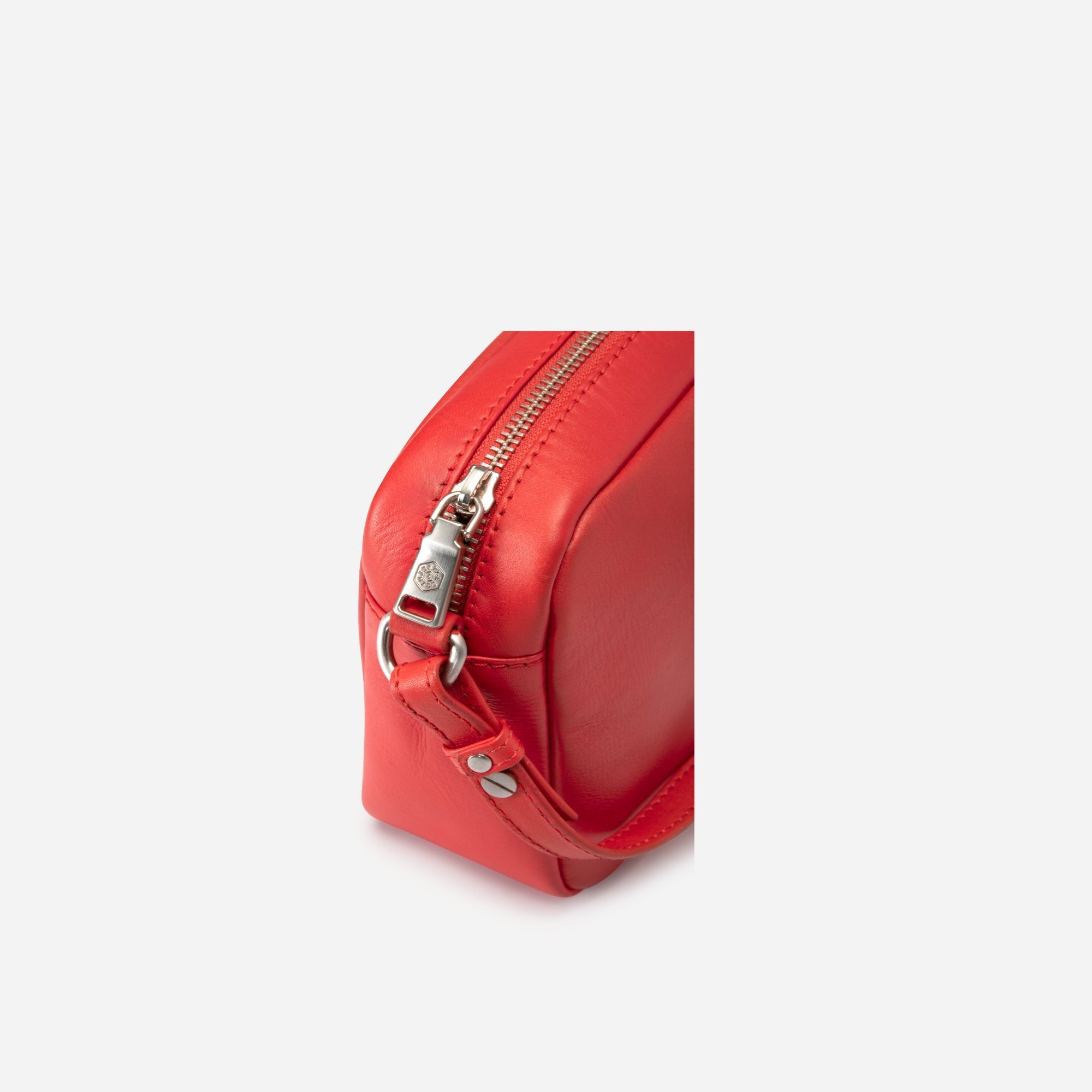 Small Crossbody bag in Candy Apple color with vibrant lining, showcasing its stylish design and compact size.