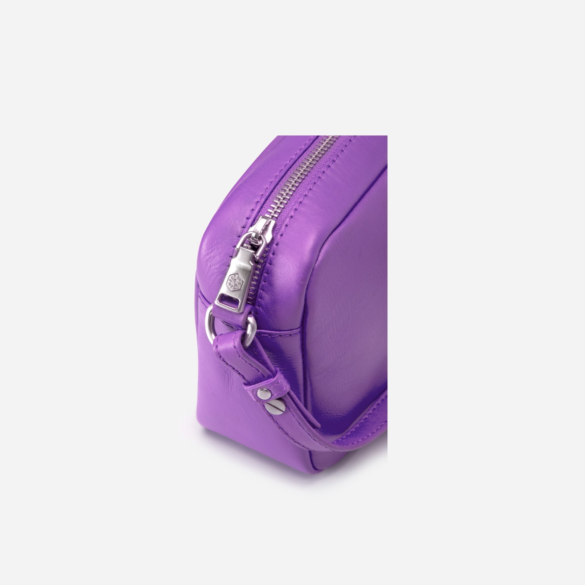 Small Crossbody bag in Electric Iris color with vibrant lining, showcasing its sleek design and spacious interior.