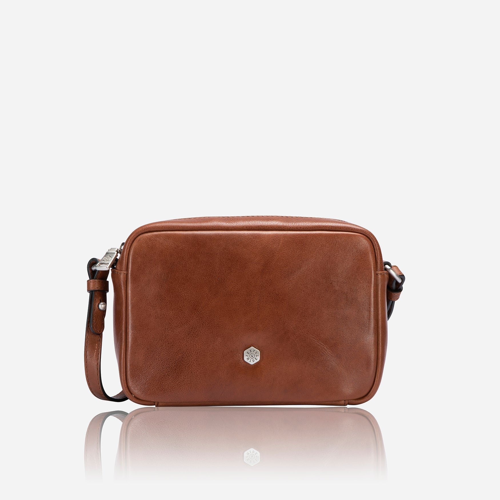 Small tan crossbody bag with vibrant lining, stylish design, and adjustable strap.