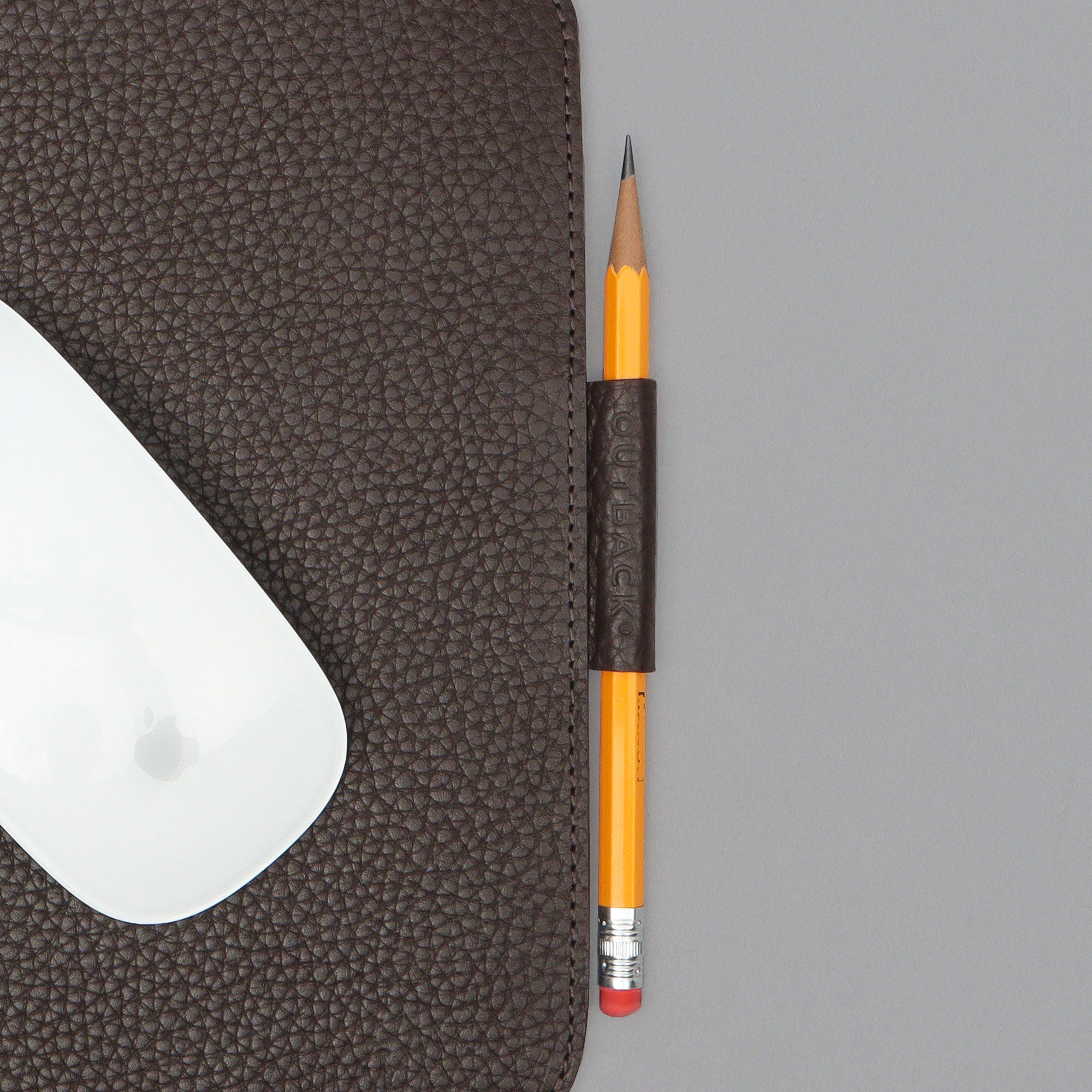 A square mouse pad made of premium full grain leather, featuring a smooth surface and space for a pen or Apple Pencil, showcasing its elegant design.